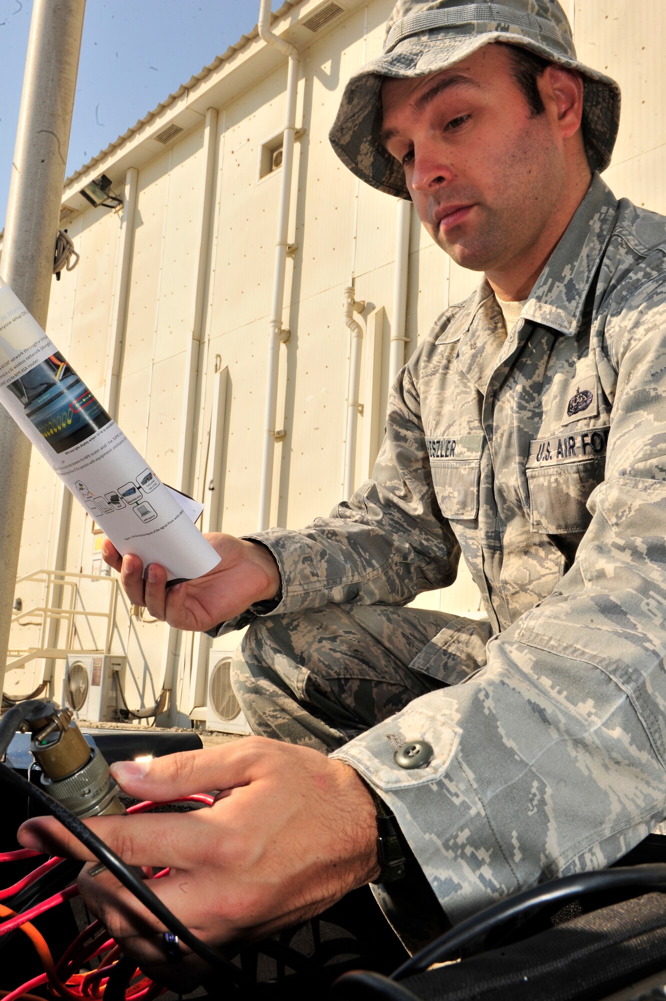 SOUTHWEST ASIA -- U.S. Air Force Staff Sgt. Bradley Keszler, 380th Expeditionary Communications Squadron radio frequency transmissions system craftsman, performs an operations check on the Communications Fly-Away Kit (CFK) Nov. 3, 2012. The CFK allows access to the Non-Secure Internet Protocol Router, Secure Internet Protocol Router, and Voice Over Secure Internet Protocol within 30 minutes during emergencies and contingencies. (U.S. Air Force photo/Tech. Sgt. Christina M. Styer) (RELEASED)