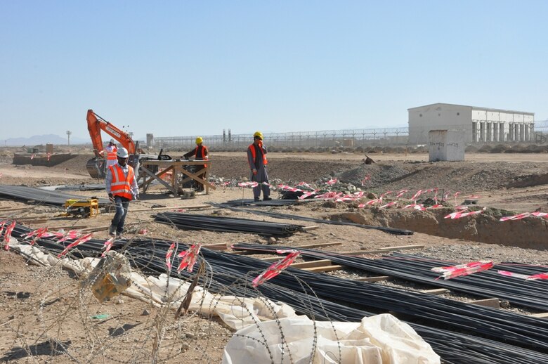 Workers make progress at the Regional Military Training Center construction site in Kandahar province Nov. 18. USACE awarded the project to an Afghan company for $42 million. When complete, the RMTC will be the site of Basic Warrior Training, follow-on specialty training and day-to-day operations for up to 3,000 personnel. The project includes the design, material, labor and equipment to construct administration buildings, dining facilities, a fitness center, medical clinic, small arms storage, parking areas, barracks and is about 50 percent complete.