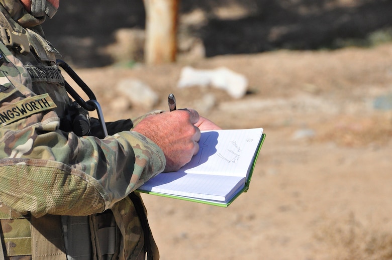 Bill Hollingsworth P.E., a civil engineer from the 565th Engineer Detachment Forward Engineer Support Team - Advance draws a sketch during a road survey conducted, Nov. 7, 2012, for the purposes of providing designs and specifications, a statement of work and cost estimate to facilitate construction of a paved road at Shur Andam Industrial Park.