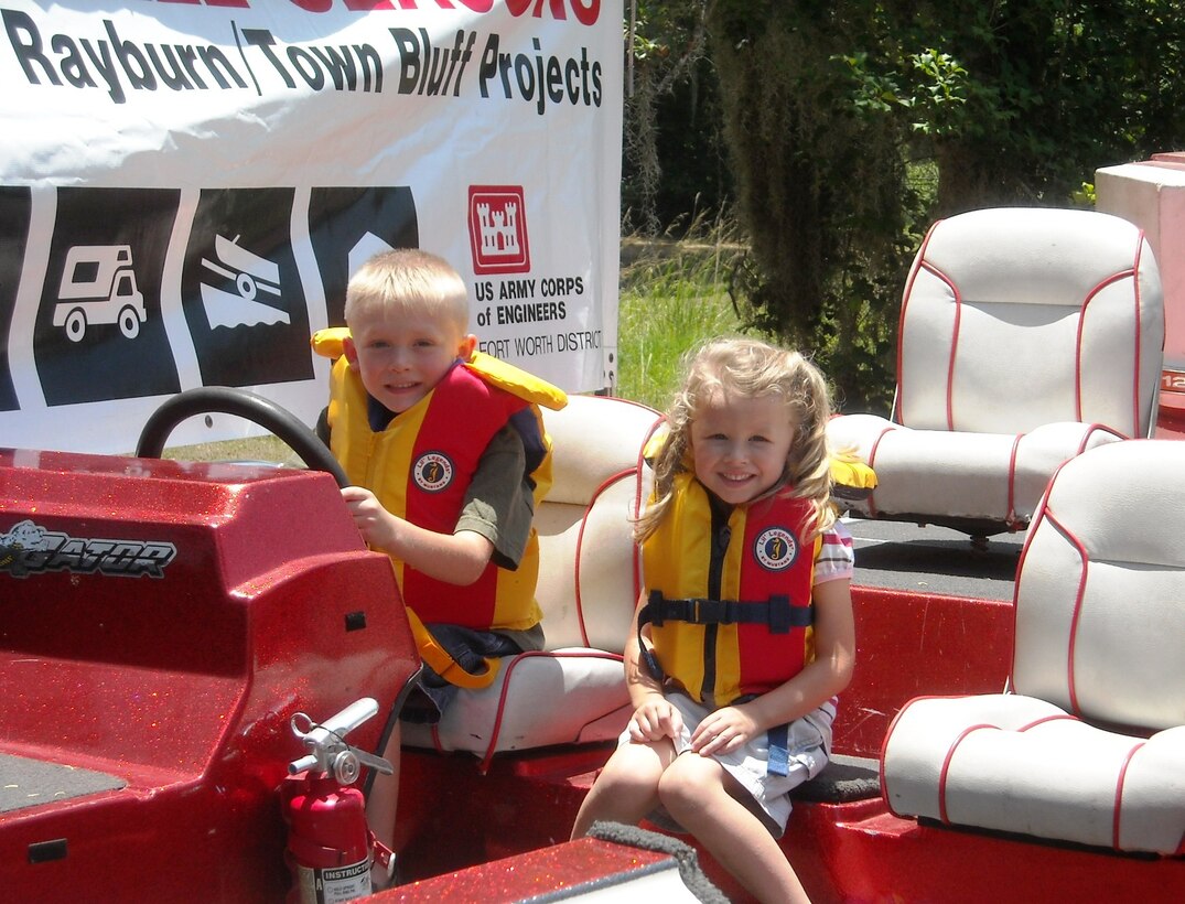 Unidentified children enjoy a boat on land during a water safety event at Town Bluff/BA Steinhagen Lake on May 12, 2012.