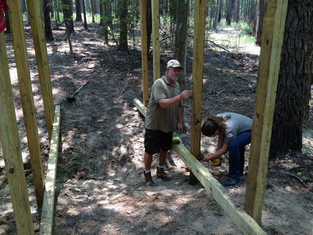 Volunteer Mark Smith and Summer Ranger Tamara Bennett work on building a trail bridge at Sam Rayburn Lake on June 26, 2012.