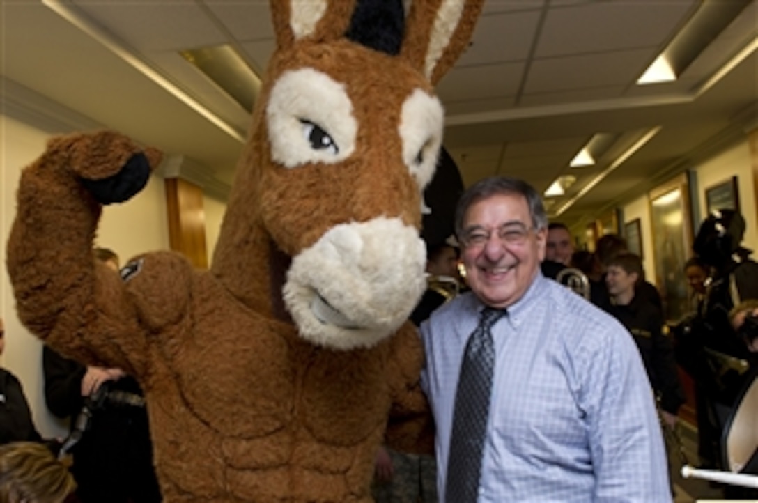 Secretary of Defense Leon E. Panetta poses for photos with the West Point mascot during a pep rally held in the halls of the Pentagon on Dec. 7, 2012.  The West Point Black Knights take on the Naval Academy Midshipmen in the 113th meeting between the two service schools at Philadelphia's Lincoln Financial Field on Saturday, Dec. 8th.  