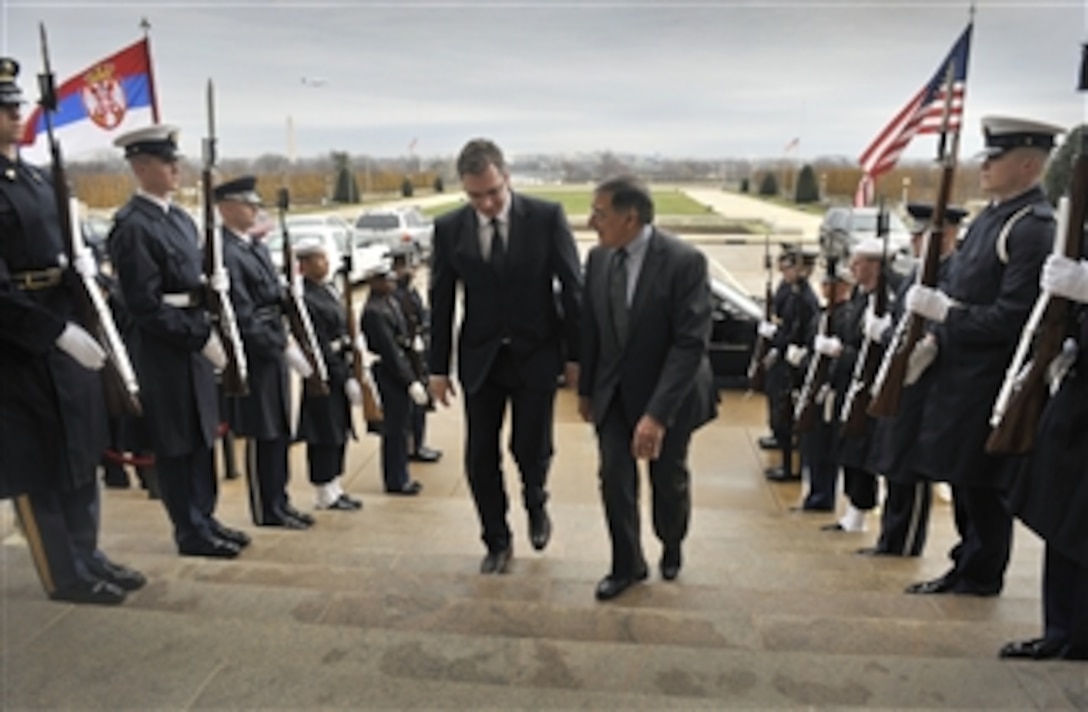 Secretary of Defense Leon E. Panetta, right, escorts Serbia's Minister of Defense Aleksandar Vucic through an honor cordon and into the Pentagon on Dec. 7, 2012.  Panetta and Vucic will meet to discuss national and regional security items of interest to both nations.  