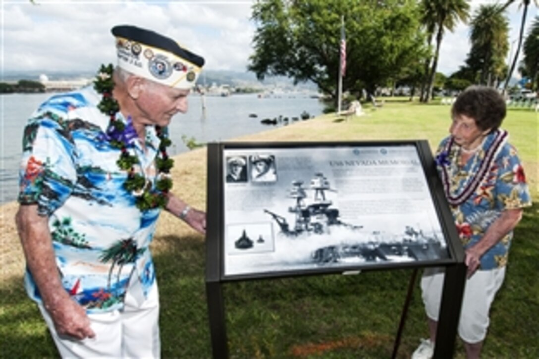 Woodrow Derby, who served aboard the former battleship the USS Nevada, left, and his wife, Christine, visit the new the USS Nevada wayside exhibit at Hospital Point at Joint Base Pearl Harbor-Hickam, Hawaii, Dec. 6, 2012. The Nevada was the only battleship able to get underway during the Dec. 7, 1941, attack.