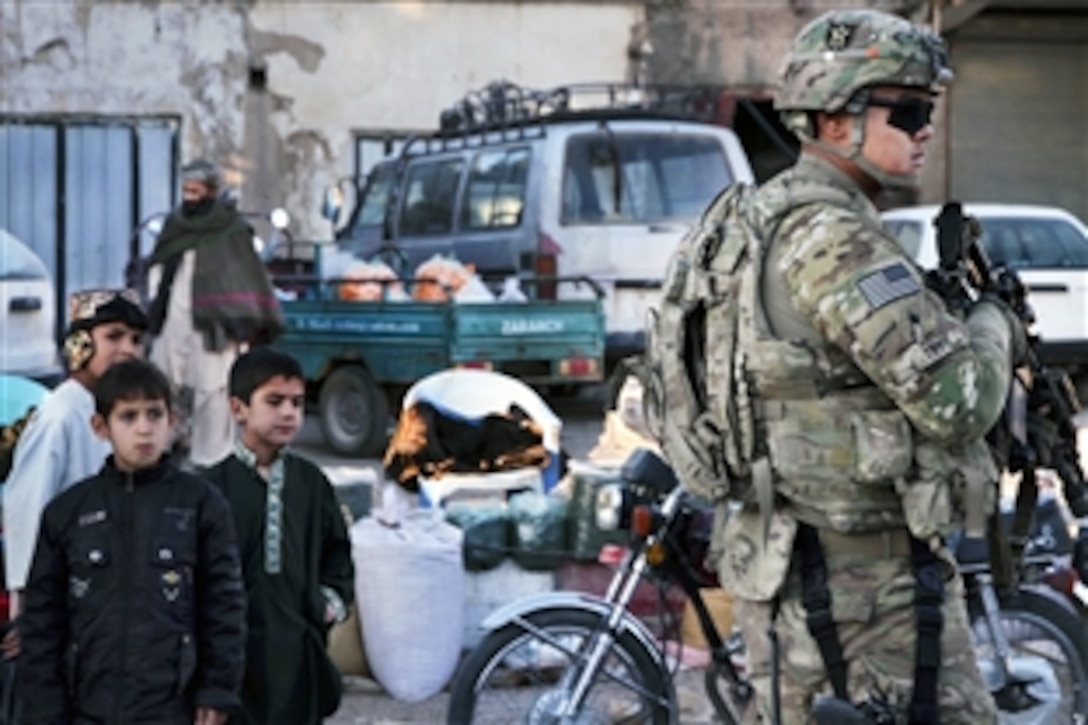 U.S. Army Spc. Samnith Thy provides security outside during a youth meeting in Farah City, Afghanistan, Dec. 2, 2012. Thy is assigned to Provincial Reconstruction Team Farah.