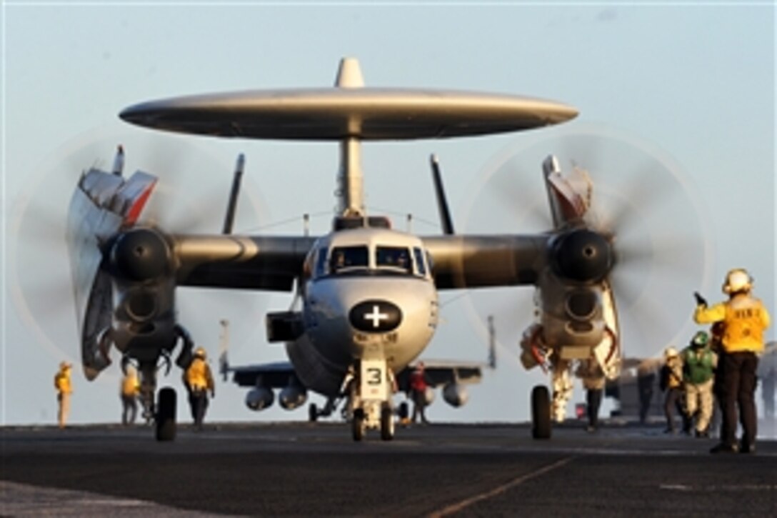 A sailor directs an E-2C Hawkeye to the catapults aboard the aircraft carrie USS Dwight D. Eisenhower under way in the Mediterranean Sea, Dec. 5, 2012. The Dwight D. Eisenhower is en route to its homeport in Norfolk, Va., after operating in the U.S. 5th and 6th Fleet areas of responsibility.