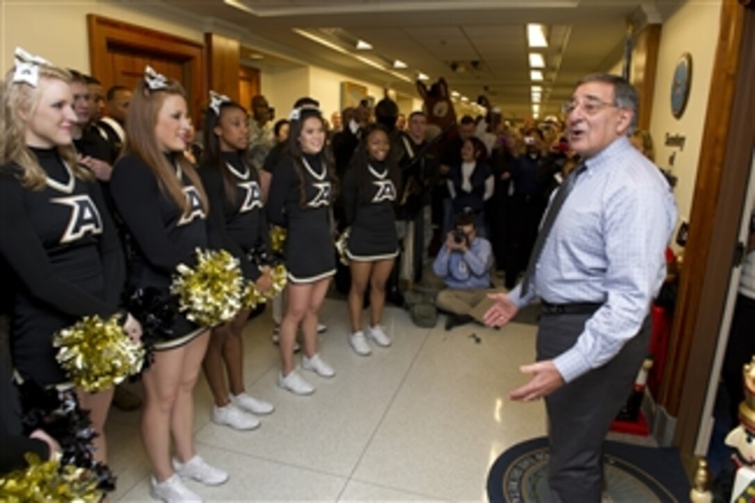 Secretary of Defense Leon E. Panetta greets the U.S. Military Academy cheerleaders and band during a pep rally held in the halls of the Pentagon on Dec. 7, 2012.  The West Point Black Knights take on the Naval Academy Midshipmen in the 113th meeting between the two service schools at Philadelphia's Lincoln Financial Field on Saturday, Dec. 8th.  