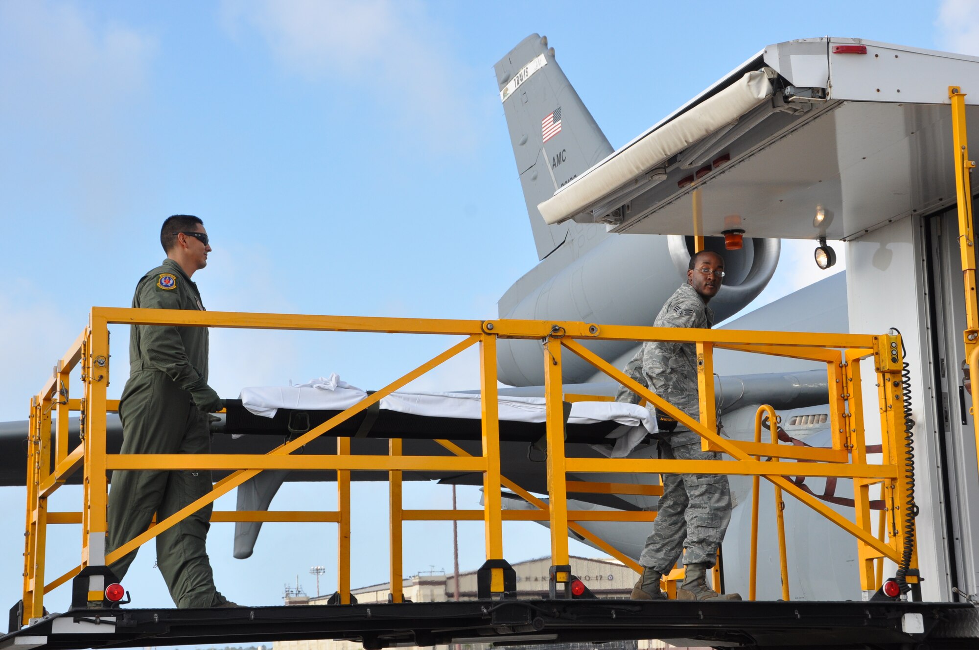 Aeromedical Evacuation crew members transport a litter onto a KC-10 Extender Dec. 3 at Joint Base Pearl Harbor-Hickam. The Extender is undergoing "proof of principle" missions to determine its capability for supporting combined cargo and aeromedical evacuation missions on Pacific Air Force channels. (U.S. Air Force photo/1st Lt. Angela Martin) 