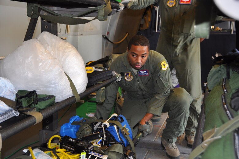 Staff Sgt. Ross Rudolph, 18th Aeromedical Evacuation Squadron technician, secures AE equipment onboard a KC-10 Extender at Joint Base Pearl Harbor-Hickam Dec. 3. Inflight kits include about 750 pounds of AE equipment such as heart monitors, frequency converters, litters and oxygen. (U.S. Air Force photo/1st Lt. Angela Martin) 