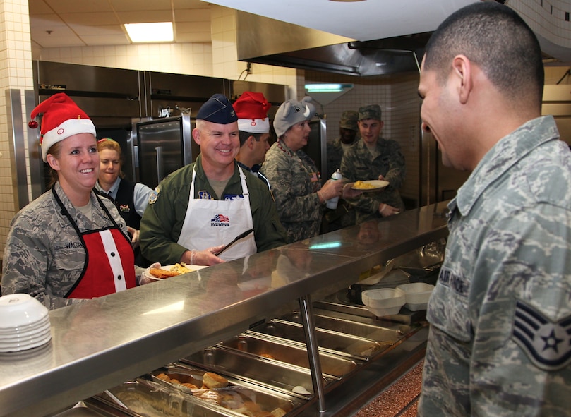 Lt. Col. Lori Walden and Col. James Lackey enjoy serving up breakfast to Staff Sgt. Daniel Sanchez, during the annual 'Cracked Egg' at the Scott Air Force Base dining facility on Dec. 8.  The event features 932nd Airlift Wing leadership and unit commanders working the main line and socializing with fellow Reservists to promote holiday cheer.  (U. S. Air Force photo/ Tech. Sgt. Christopher Parr)


