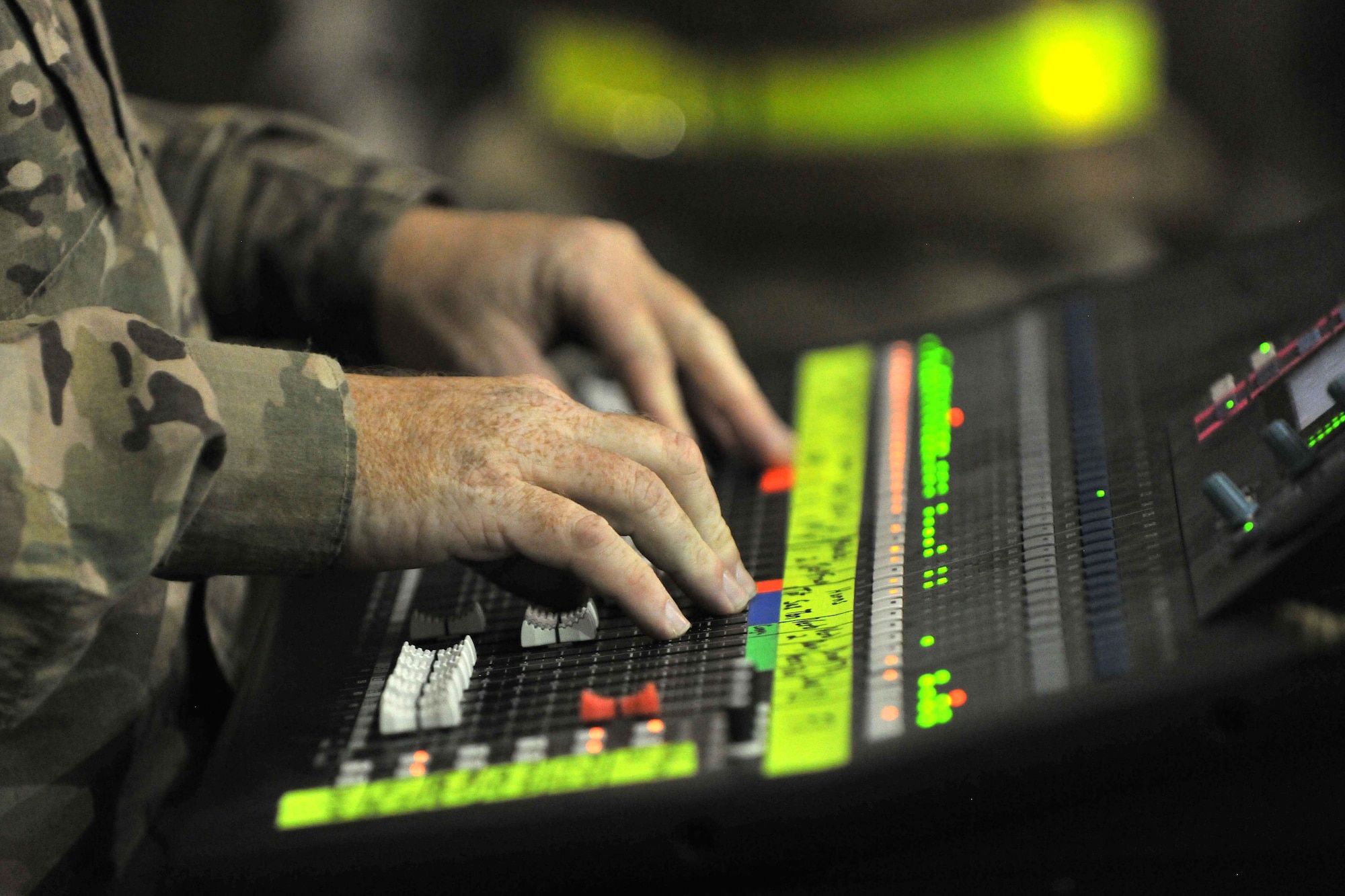 Tech. Sgt. Steven Moore, member of the U.S. Air Forces Central Command Band, controls the audio during a concert for flightline personnel at Bagram Airfield, Afghanistan, Dec. 7, 2012. USAFCENT band, "Total Force's," flightline performance was the last of three venues in which they played popular hits from the past couple of decades. (U.S. Air Force photo/Senior Airman Chris Willis)