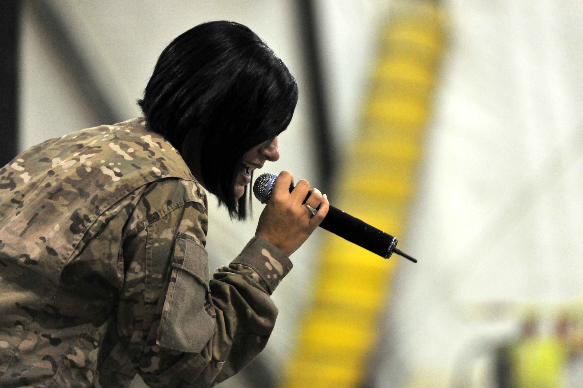 Tech. Sgt. Frances Kness, a member of the U.S. Air Forces Central Command Band, performs for flightline personnel at Bagram Airfield, Afghanistan, Dec. 7, 2012. USAFCENT band, "Total Force's," flightline performance was the last of three venues in which they played popular hits from the past couple of decades. (U.S. Air Force photo/Senior Airman Chris Willis)