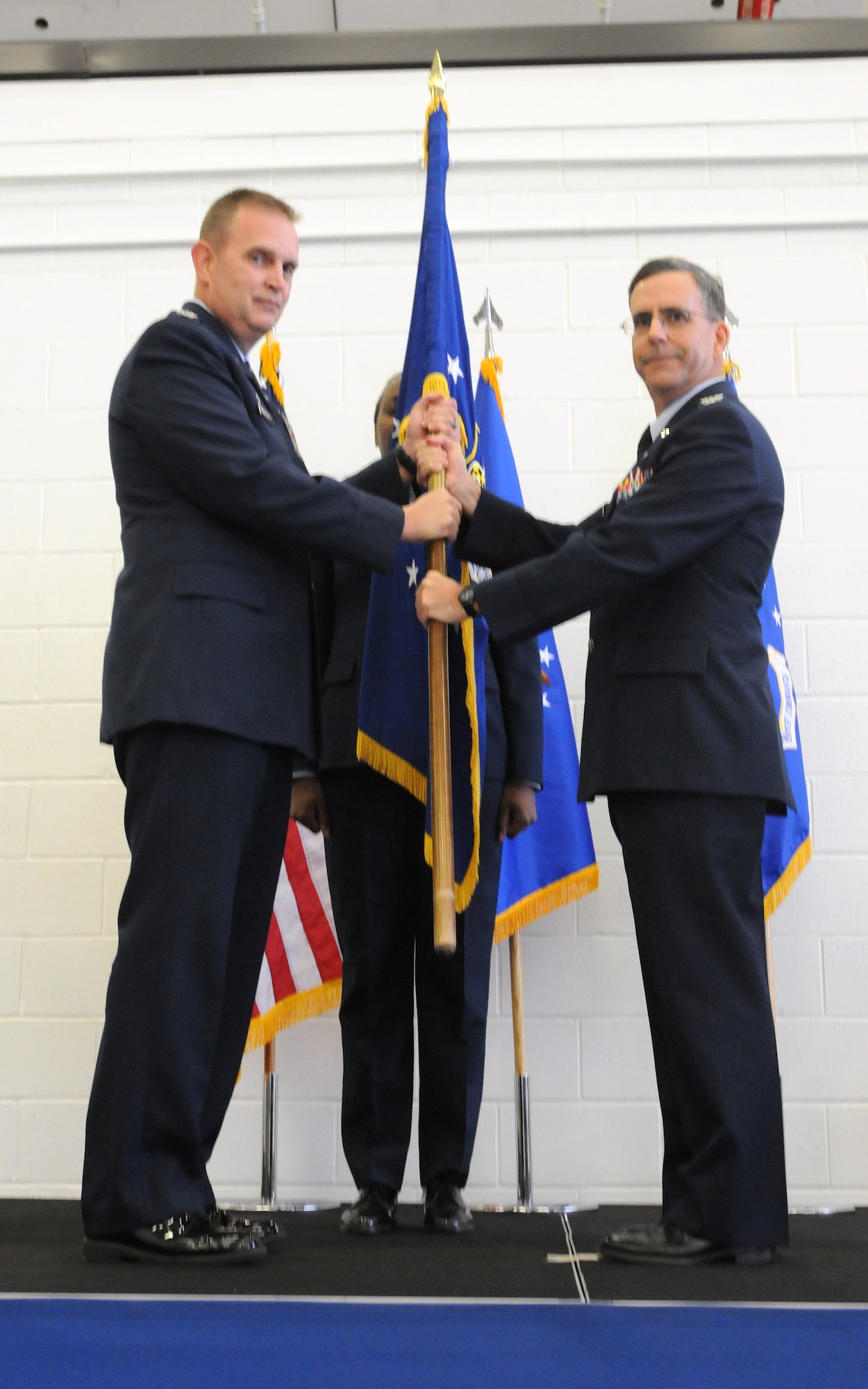 JOINT BASE ANDREWS, Md. --  Col. William H. Mason, 459th Air Refueling Wing commander, passes the 459th Maintenance Group guidon to Col. Donald C. Robison during a change of command ceremony here Dec. 9, 2012. Colonel Robison assumes command of the 459th MXG from Colonel Banavige, who is transferring to Tinker Air Force Base, Okla., where she will be an Individual Mobilization Augmentee.  (U.S. Air Force photo/Tech Sgt Steve Lewis)