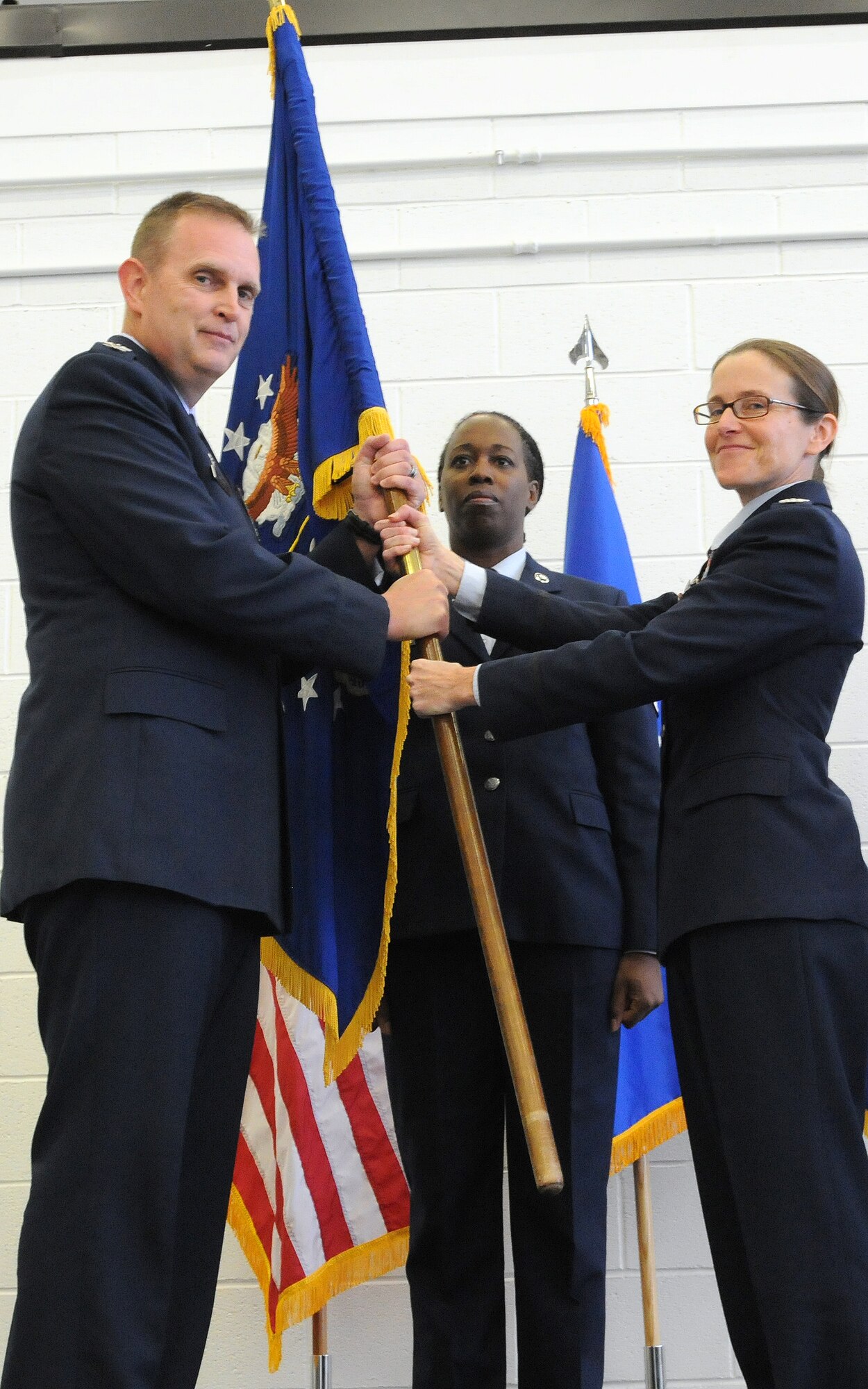 JOINT BASE ANDREWS, Md. -- Col. Maureen G. Banavige, former 459th Maintenance Group commander, relinquishes the guidon to Col. William H. Mason, 459th Air Refueling Wing commander, during a change of command ceremony here Dec. 9, 2012. Colonel Banavige is transferring to Tinker Air Force Base, Okla., where she will be an Individual Mobilization Augmentee. Col. Donald C. Robison now assumes command of the 459th MXG. (U.S. Air Force photo/Tech Sgt Steve Lewis)