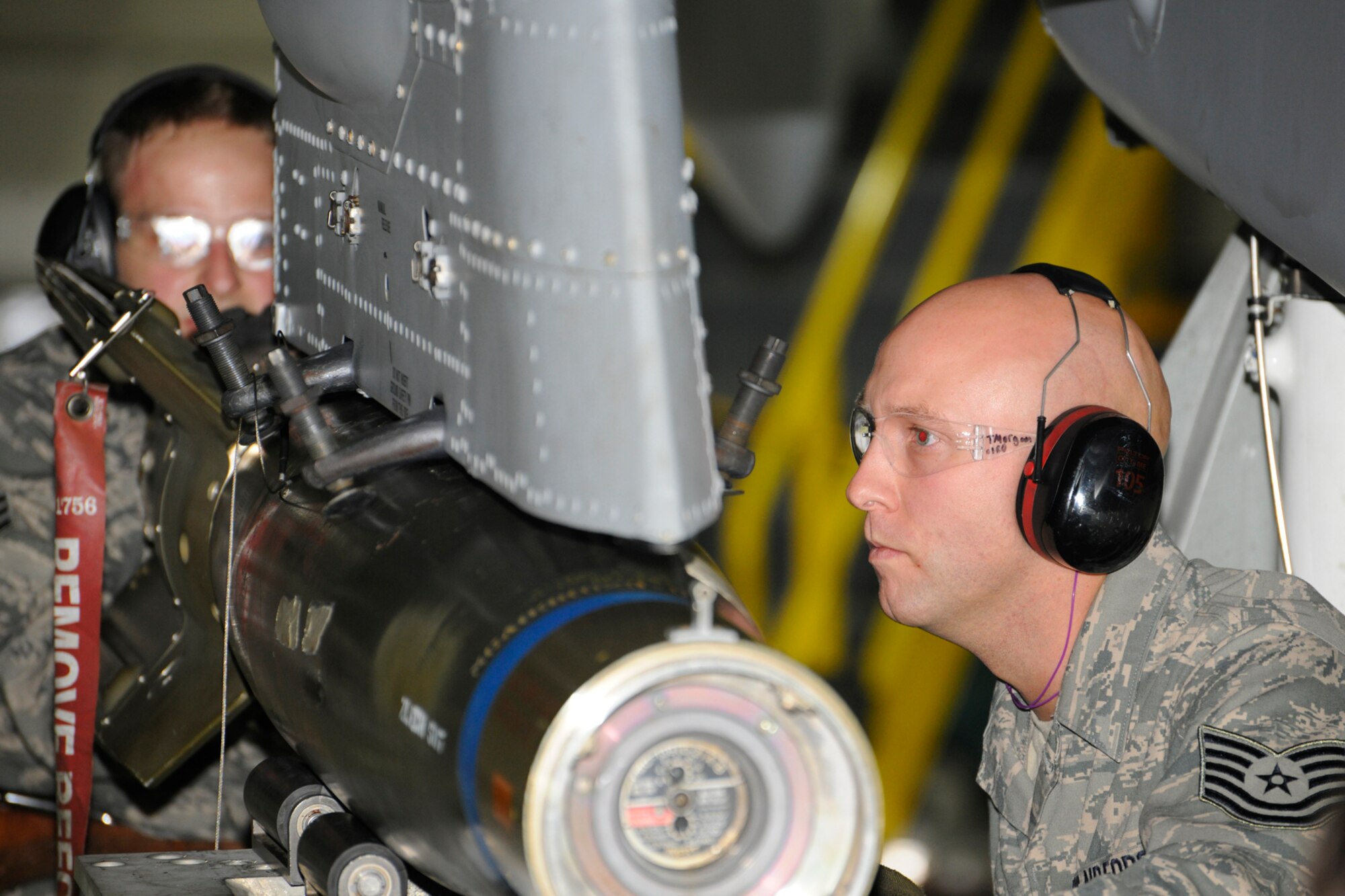 Technical Sgt. Travis Morgan loads a GBU 12 on to an A-10 Thunderbolt II aircraft during the 127th Aircraft Maintenance Squadron’s annual loadeo competition Dec. 8, 2012, at Selfridge Air National Guard Base, Mich. Assisting Morgan is Senior Airman Vince Kelly. During the competition, weapons load crews are judged based on their knowledge of weapons systems and are graded while loading a series of bombs and missiles onto an A-10 Thunderbolt II aircraft. The team of Morgan, Kelly and Senior Airman Tim Reid were named the top weapons load team after the competition. (Air National Guard photo by TSgt. David Kujawa)