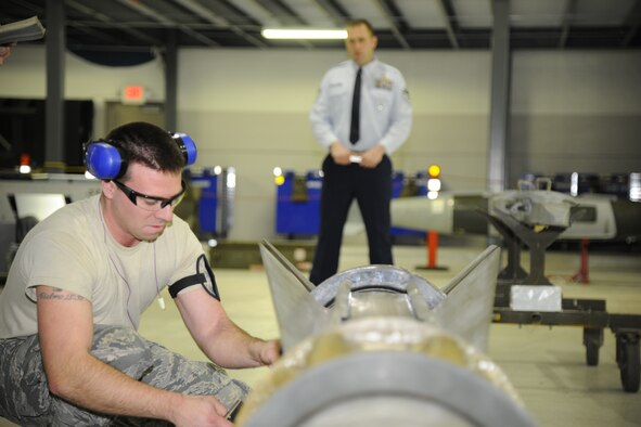 Airman 1st Class Ben Engel works on an AGM-65 while being watched by Master Sgt. James Richards during the 127th Aircraft Maintenance Squadron’s annual loadeo competition Dec. 8, 2012, at Selfridge Air National Guard Base, Mich. During the competition, weapons load crews are judged based on their knowledge of weapons systems and are graded while loading a series of bombs and missiles onto an A-10 Thunderbolt II aircraft. (Air National Guard photo by TSgt. David Kujawa)