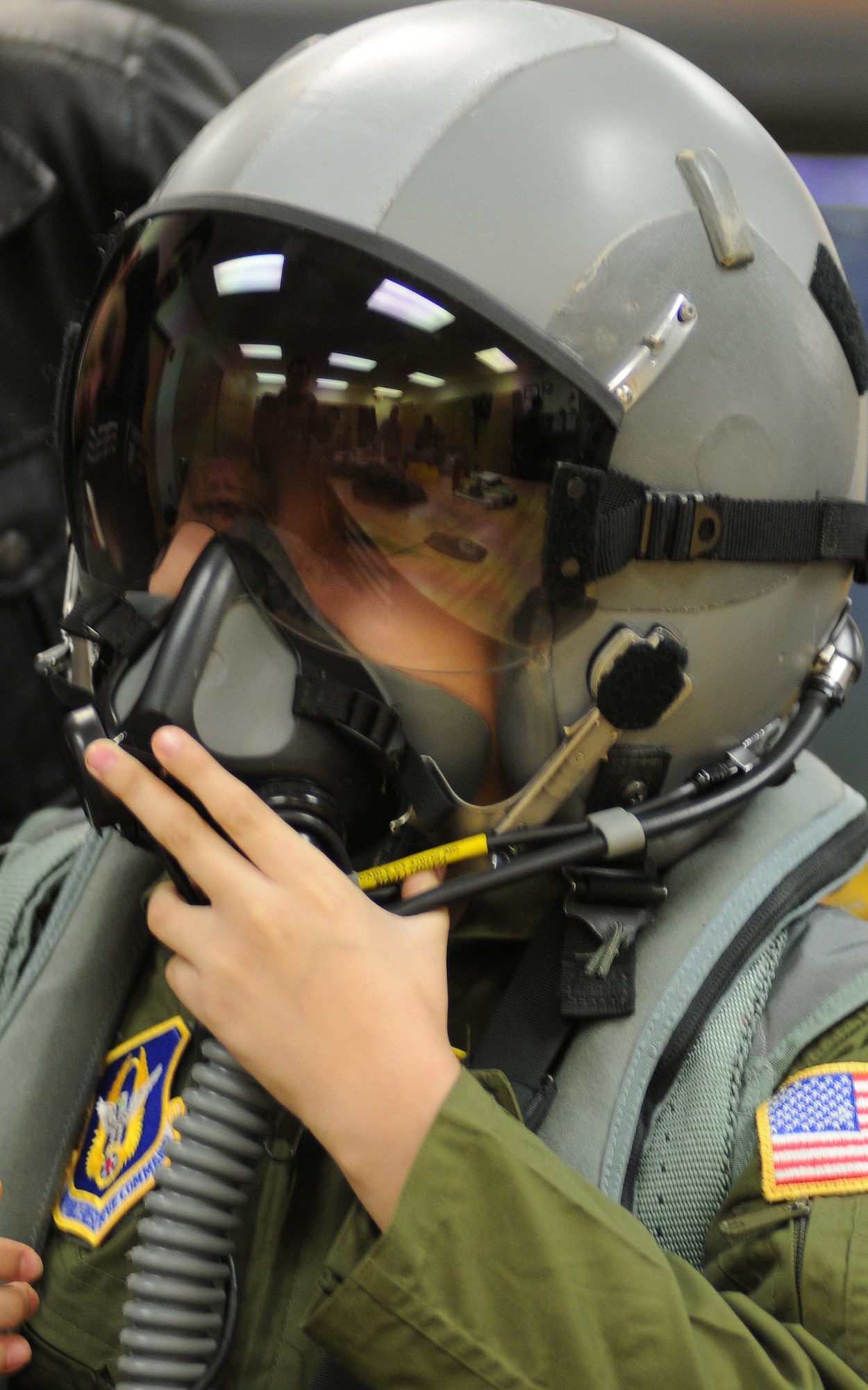 JOINT BASE ANDREWS, Md. -- Melvin Maldonado,10,  tries on F-16 pilot gear from the 113th Wing during Team Andrew's Pilot for a Day program here Dec. 7, 2012. The Pilot for a Day program is coordinated through the Air Force Reserve Command's 459th Air Refueling Wing and the District of Columbia Air National Guard's 113th WG. Pilot for a Day or "P4D" is a community outreach program that allows military and civilian children of all ages who suffer from serious or chronic medical conditions to visit an installation for the day to tour wing and base facilities. (U.S. Air Force photo/Tech Sgt Steve Lewis)