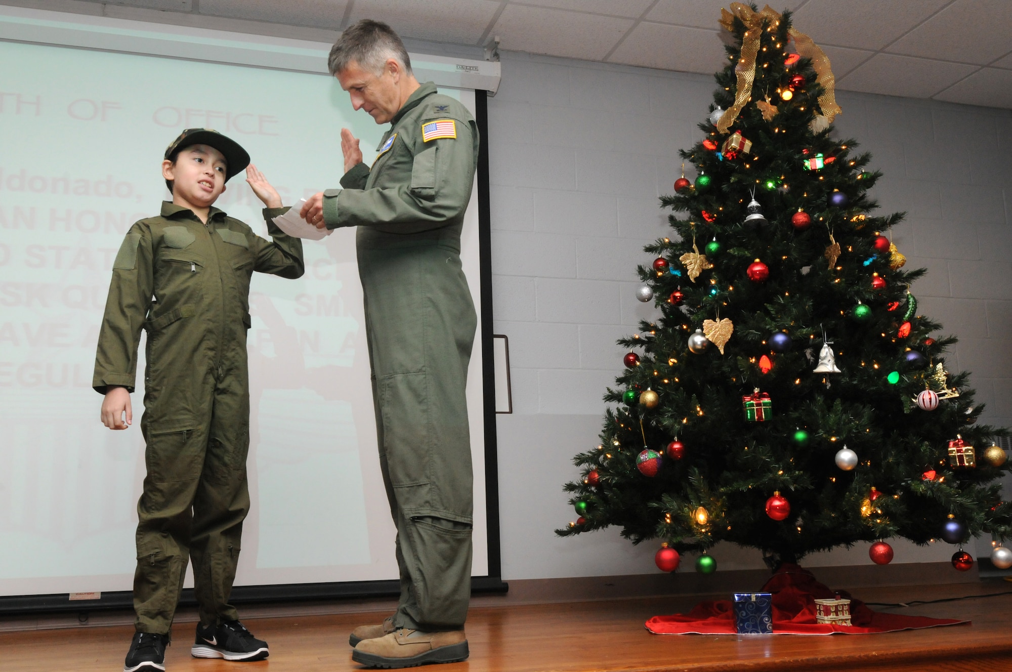 JOINT BASE ANDREWS, Md. -- Melvin Maldonado, 10, takes the oath of enlistment from Col. Gary W. Dickinson, 459th Air Refueling Wing vice wing commander, during Team Andrew's Pilot for a Day program here Dec. 7, 2012. Coordinated through the Air Force Reserve Command's 459th ARW and the District of Columbia Air National Guard's 113th Wing, Pilot for a Day or "P4D" is a community outreach program that allows military and civilian children of all ages who suffer from serious or chronic medical conditions to visit an installation for the day to tour wing and base facilities. (U.S. Air Force photo/Tech Sgt Steve Lewis)