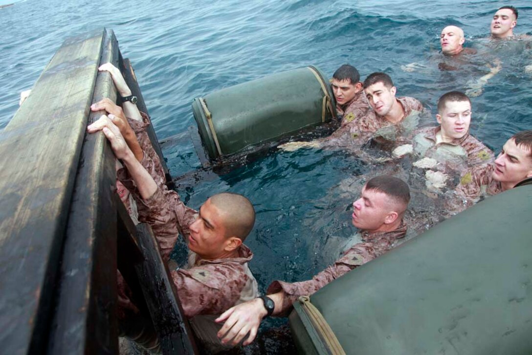 Marines with Battalion Landing Team 3/5, 15th Marine Expeditionary Unit work to move through a water obstacle course at the French Combat Warfare Training Center in Djibouti, Dec. 4. The training, led by instructors from French forces of the French CWTC in Djibouti, involved obstacle courses on land and in the water different from ones Marines and sailors are used to seeing back home. The 15th MEU is deployed as part of the Peleliu Amphibious Ready Group as a U.S. Central Command theater reserve force, providing support for maritime security operations and theater security cooperation efforts in the U.S. 5th Fleet area of responsibility. (U.S. Marine Corps photo by Cpl. John Robbart III)