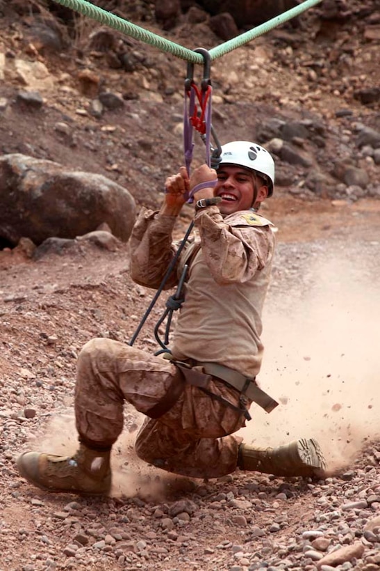 Corporal Henry E. Cisneros, company clerk, Headquarters and Service Company, Battalion Landing Team 3/5, 15th Marine Expeditionary Unit, slides down the end of the zip-line at the French Combat Warfare Training Center in Djibouti, Dec. 4. The training, led by instructors from French forces of the French CWTC in Djibouti, involved obstacle courses on land and in the water different from ones Marines and sailors are used to seeing back home. The 15th MEU is deployed as part of the Peleliu Amphibious Ready Group as a U.S. Central Command theater reserve force, providing support for maritime security operations and theater security cooperation efforts in the U.S. 5th Fleet area of responsibility. Cisneros, 21, is from Palmdale, Calif. (U.S. Marine Corps photo by Cpl. John Robbart III)