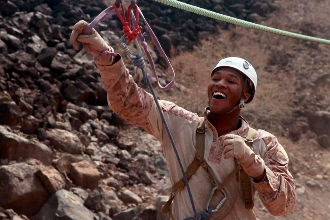 Hospitalman Matthew S. Okonkwo, Headquarters and Service Company, Battalion Landing Team 3/5, 15th Marine Expeditionary Unit laughs after sliding down the end of the zip-line in Djibouti, Dec. 4. The training, led by instructors from French forces of the French CWTC in Djibouti, involved obstacle courses on land and in the water different from ones Marines and sailors are used to seeing back home. The 15th MEU is deployed as part of the Peleliu Amphibious Ready Group as a U.S. Central Command theater reserve force, providing support for maritime security operations and theater security cooperation efforts in the U.S. 5th Fleet area of responsibility. Okonkwo, 22, is from Dothan, Ala. (U.S. Marine Corps photo by Cpl. John Robbart III)