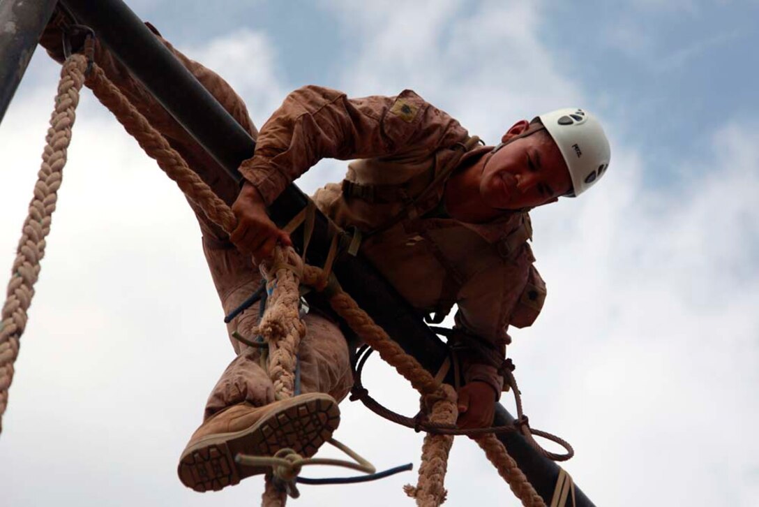 Sergeant Christopher R. Llanes, radio operator, Headquarters and Service Company, Battalion Landing Team 3/5, 15th Marine Expeditionary Unit, maneuvers over an obstacle during a team-building obstacle course at the French Combat Warfare Training Center in Djibouti, Dec. 4. The training, led by instructors from French forces of the French CWTC in Djibouti, involved obstacle courses on land and in the water different from ones Marines and sailors are used to seeing back home. The courses emphasized teamwork to make it through each obstacle. The 15th MEU is deployed as part of the Peleliu Amphibious Ready Group as a U.S. Central Command theater reserve force, providing support for maritime security operations and theater security cooperation efforts in the U.S. 5th Fleet area of responsibility. Llanes, 27, is from Long Beach, Calif. (U.S. Marine Corps photo by Cpl. John Robbart III)