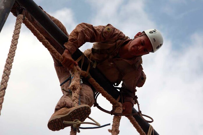 Sergeant Christopher R. Llanes, radio operator, Headquarters and Service Company, Battalion Landing Team 3/5, 15th Marine Expeditionary Unit, maneuvers over an obstacle during a team-building obstacle course at the French Combat Warfare Training Center in Djibouti, Dec. 4. The training, led by instructors from French forces of the French CWTC in Djibouti, involved obstacle courses on land and in the water different from ones Marines and sailors are used to seeing back home. The courses emphasized teamwork to make it through each obstacle. The 15th MEU is deployed as part of the Peleliu Amphibious Ready Group as a U.S. Central Command theater reserve force, providing support for maritime security operations and theater security cooperation efforts in the U.S. 5th Fleet area of responsibility. Llanes, 27, is from Long Beach, Calif. (U.S. Marine Corps photo by Cpl. John Robbart III)