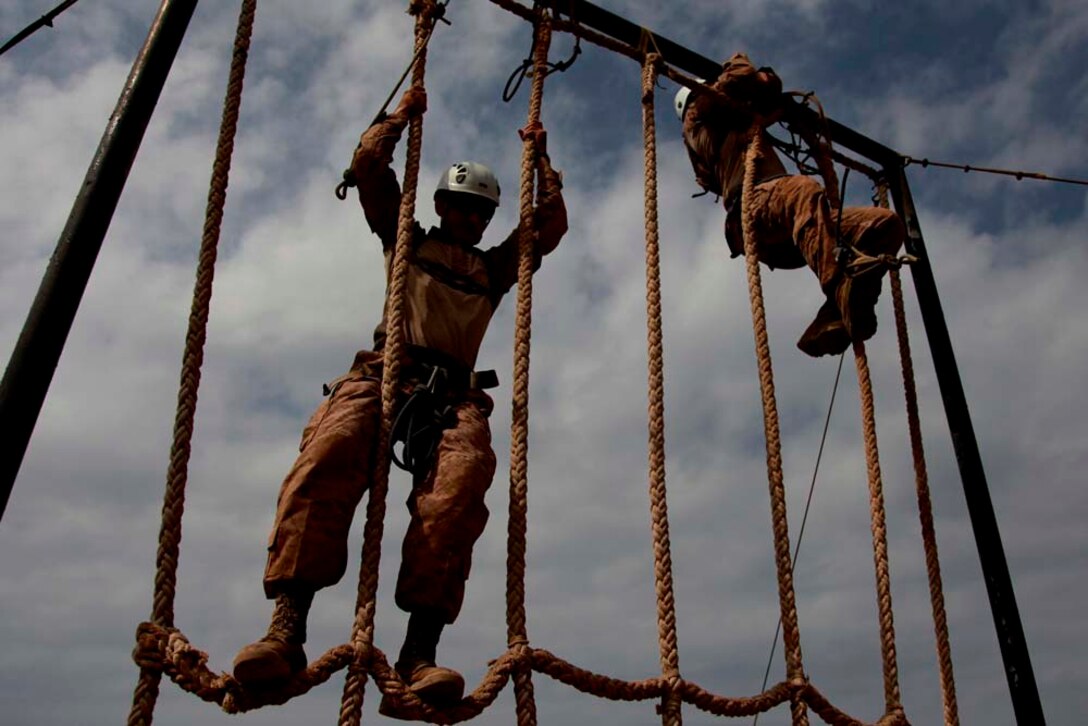 Marines with Battalion Landing Team 3/5, 15th Marine Expeditionary Unit, climb a rope wall during a team-building obstacle course at the French Combat Warfare Training Center in Djibouti, Dec. 4. The training, led by instructors from French forces of the French CWTC in Djibouti, involved obstacle courses on land and in the water different from ones Marines and sailors are used to seeing back home. The 15th MEU is deployed as part of the Peleliu Amphibious Ready Group as a U.S. Central Command theater reserve force, providing support for maritime security operations and theater security cooperation efforts in the U.S. 5th Fleet area of responsibility. (U.S. Marine Corps photo by Cpl. John Robbart III)