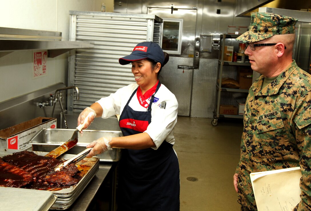 Maj. Richard Kohler, director, Marine Corps Food Service and Assistance Program, Headquarters Marine Corps, inspects how Littleton Chow Hall staff members prepare their food during his evaluation  for the Maj. Gen. W.P.T. Hill Award. 