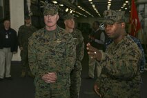 USS MESA VERDE - SSgt. Kevin Richardson, a well deck combat cargo assistant aboard the USS Mesa Verde (LPD-19), explains some of the ship's features to Brig. Gen. Blake Crowe, the deputy commander for Marine Corps Forces Command. Crowe toured the command and control spaces aboard the USS Mesa Verde and USS Bataan in order to see firsthand some of the improvements to the ships as a result of the Naval Amphibious Baseline initiative.