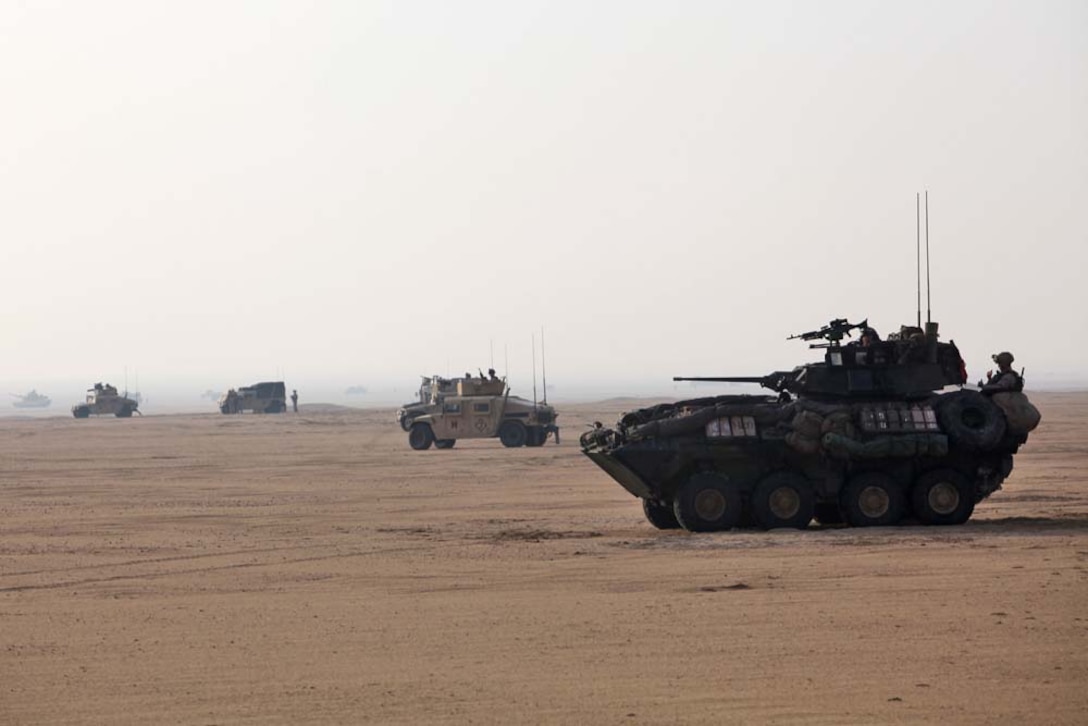 U.S. Marines assigned to Battalion Landing Team 3/5, 15th Marine Expeditionary Unit (MEU), stage vehicles near Camp Buehring, Kuwait, during exercise Eager Mace 13, Nov. 19. The U.S. Navy and Marine Corps participated in the bilateral training exercise with the Kuwait Armed Forces to expand levels of cooperation, enhance mutual maritime capabilities and promote long-term regional stability and interoperability between U.S. forces and regional partners. The 15th MEU is deployed with the Peleliu Amphibious Ready Group as a U.S. Central Command theater reserve force, providing support for maritime security operations and theater security cooperation efforts in the U.S. 5th Fleet area of responsibility. (U.S. Marine Corps photo by Cpl. Timothy R. Childers/Released)