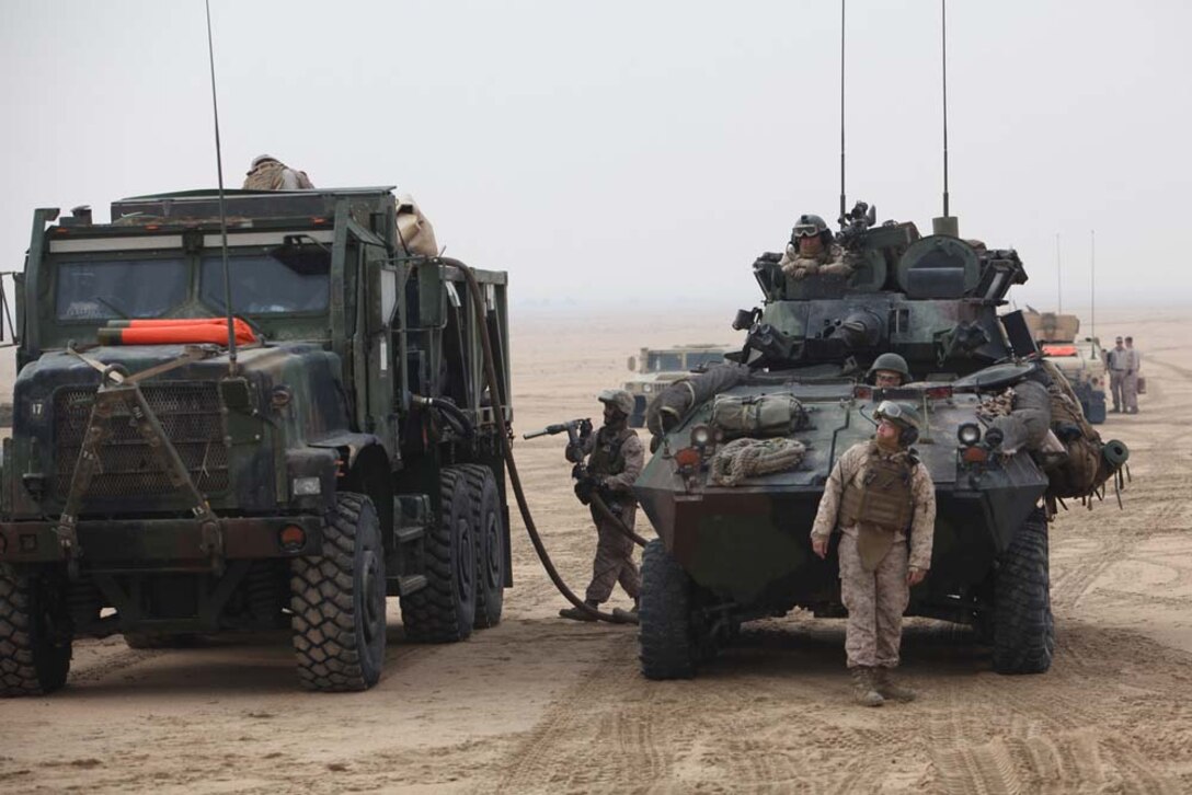 U.S. Marines assigned to 15th Marine Expeditionary Unit (MEU), refuel Light-Armored Vehicle, near Camp Buehring, Kuwait, during exercise Eager Mace 13, Nov. 19. The U.S. Navy and Marine Corps participated in the bilateral training exercise with the Kuwait Armed Forces to expand levels of cooperation, enhance mutual maritime capabilities and promote long-term regional stability and interoperability between U.S. forces and regional partners. The 15th MEU is deployed with the Peleliu Amphibious Ready Group as a U.S. Central Command theater reserve force, providing support for maritime security operations and theater security cooperation efforts in the U.S. 5th Fleet area of responsibility. (U.S. Marine Corps photo by Cpl. Timothy R. Childers/Released)