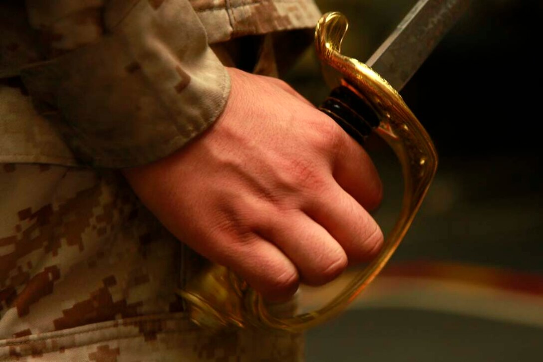 Corporal Angel A. Primo, avionics technician, Marine Medium Helicopter Squadron 364 (Rein.), 15th Marine Expeditionary Unit, practices sword manual in the hangar bay of the USS Peleliu during Corporal's Course, Dec. 3. Corporals' Course is a professional military education for enlisted Marines designed to give them the tools to become better effective small unit leaders. The 15th MEU is deployed as part of the Peleliu Amphibious Ready Group as a U.S. Central Command theater reserve force, providing support for maritime security operations and theater security cooperation efforts in the U.S. 5th Fleet area of responsibility. Primo, 22, is from Los Angeles. (U.S. Marine Corps photo by Cpl. John Robbart III)
