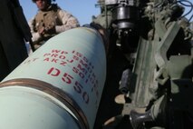 A 155mm ammunition round is prepared to be loaded into U.S. Marine Corps M-777 light towed howitzer during a supporting arms coordination exercise (SACEX) at San Clemente Island, Calif., March 14, 2008. SACEX provides coordinated weapons fire from the air, sea, and land in support of amphibious landings. (U.S. Marine Corps photo by Cpl. Stephen Holt/Released)