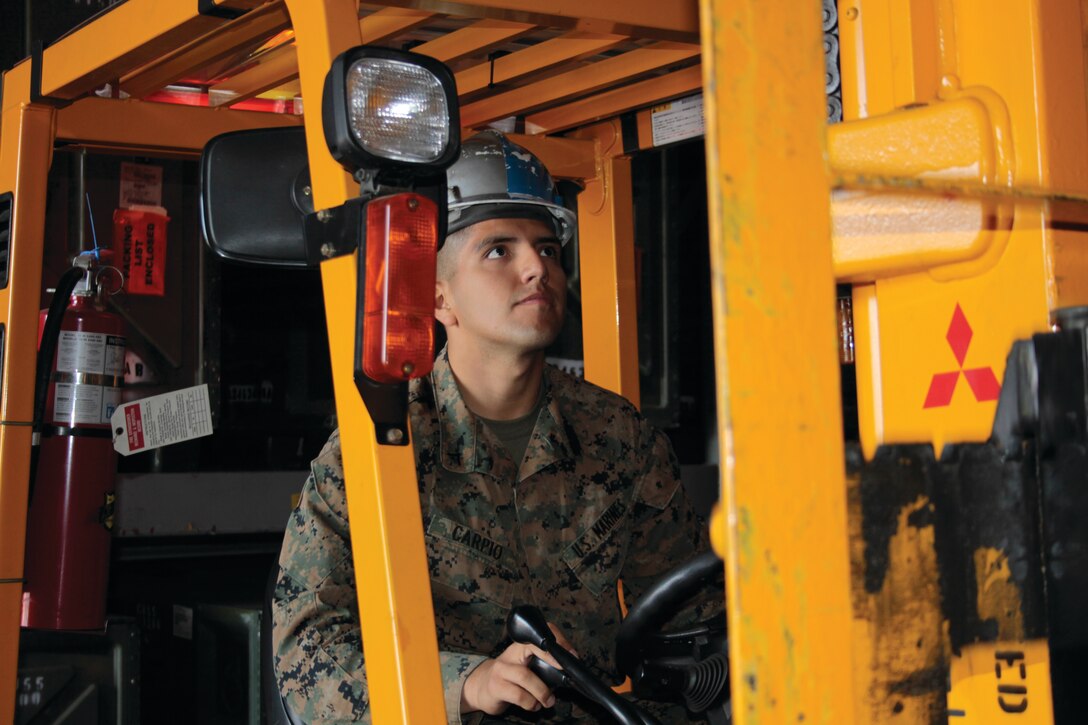 Lance Cpl. Diego Carpio, Combat Logistics Company 36 supply, uses a forklift to retrieve a box from a shelf in the warehouse here, Nov. 28, 2012. Carpio volunteered to take part in jungle warfare training at Camp Gonsalves, Okinawa, Japan, along with nine other service members from CLC-36. The final part of the training consisted of a 3.8 mile endurance course.