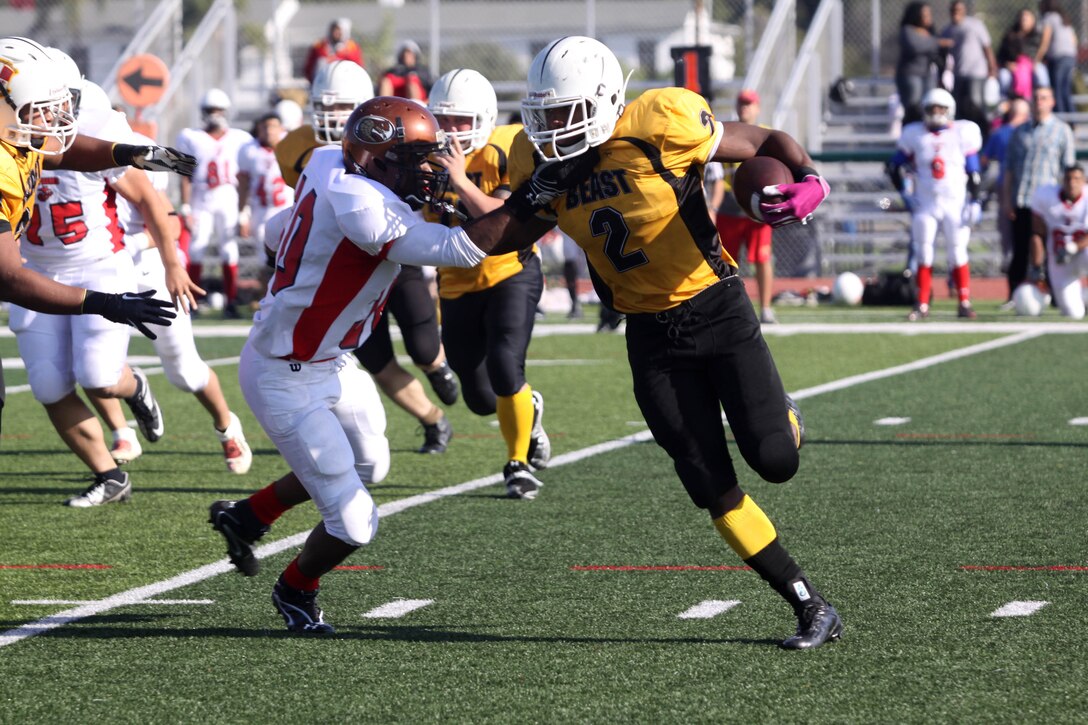 Melvin Sisk, a defensive back for 29 Palms' Marine Logistics Group football team, attempts to tackle Thaddaeus Haney, a running back for Camp Pendleton’s MLG football team, during the 2012 Best of the West Championship Football Game. Bragging rights went to Pendleton's team, known as 'the Beast', after defeating 29 Palms by a score of 28 - 0 here Dec. 8. With the win, the Beast claimed the Western Division All-Star Football Title for the third time in four years.