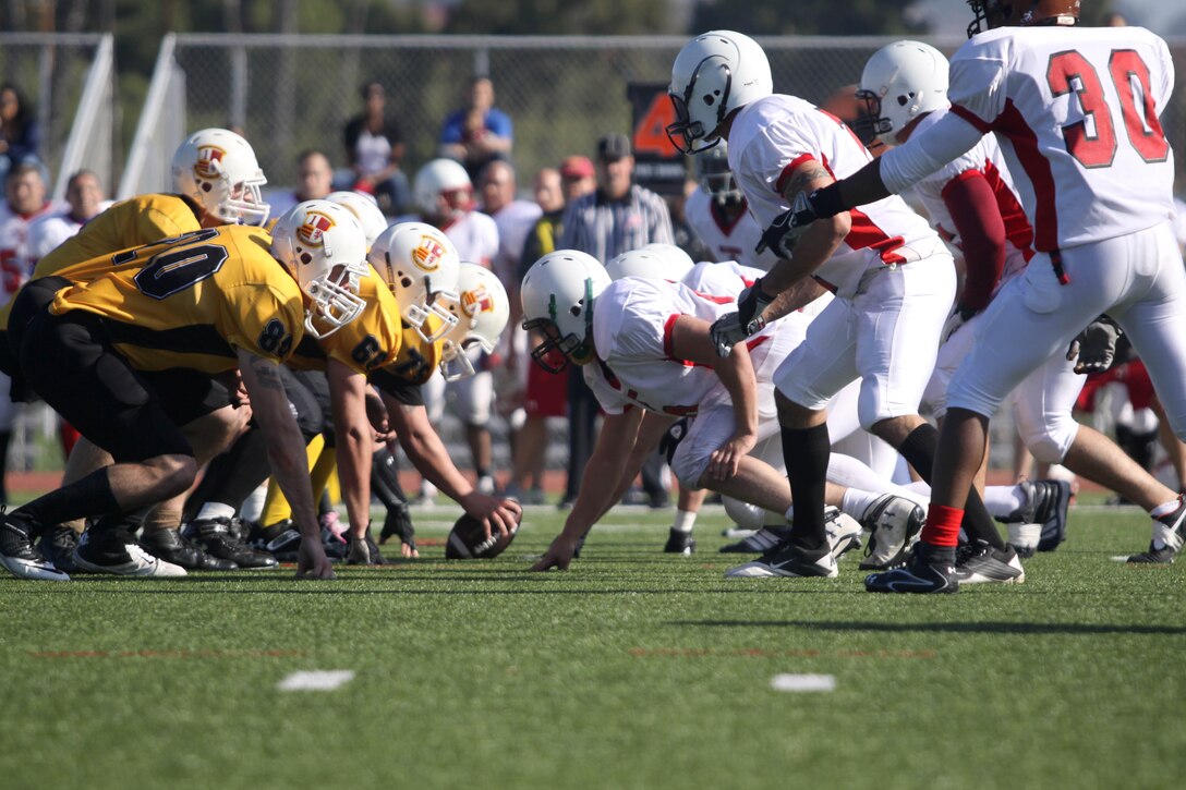 Camp Pendleton’s Marine Logistics Group football team prepares to snap the ball as 29 Palms' MLG team eagerly awaits the chance to shut down the play during the 2012 Best of the West Championship Football Game. Bragging rights went to Pendleton's MLG team, known as 'the Beast', after defeating 29 Palms' MLG by a score of 28 - 0 here Dec. 8. With the win, the Beast claimed the Western Division All-Star Football Title for the third time in four years.