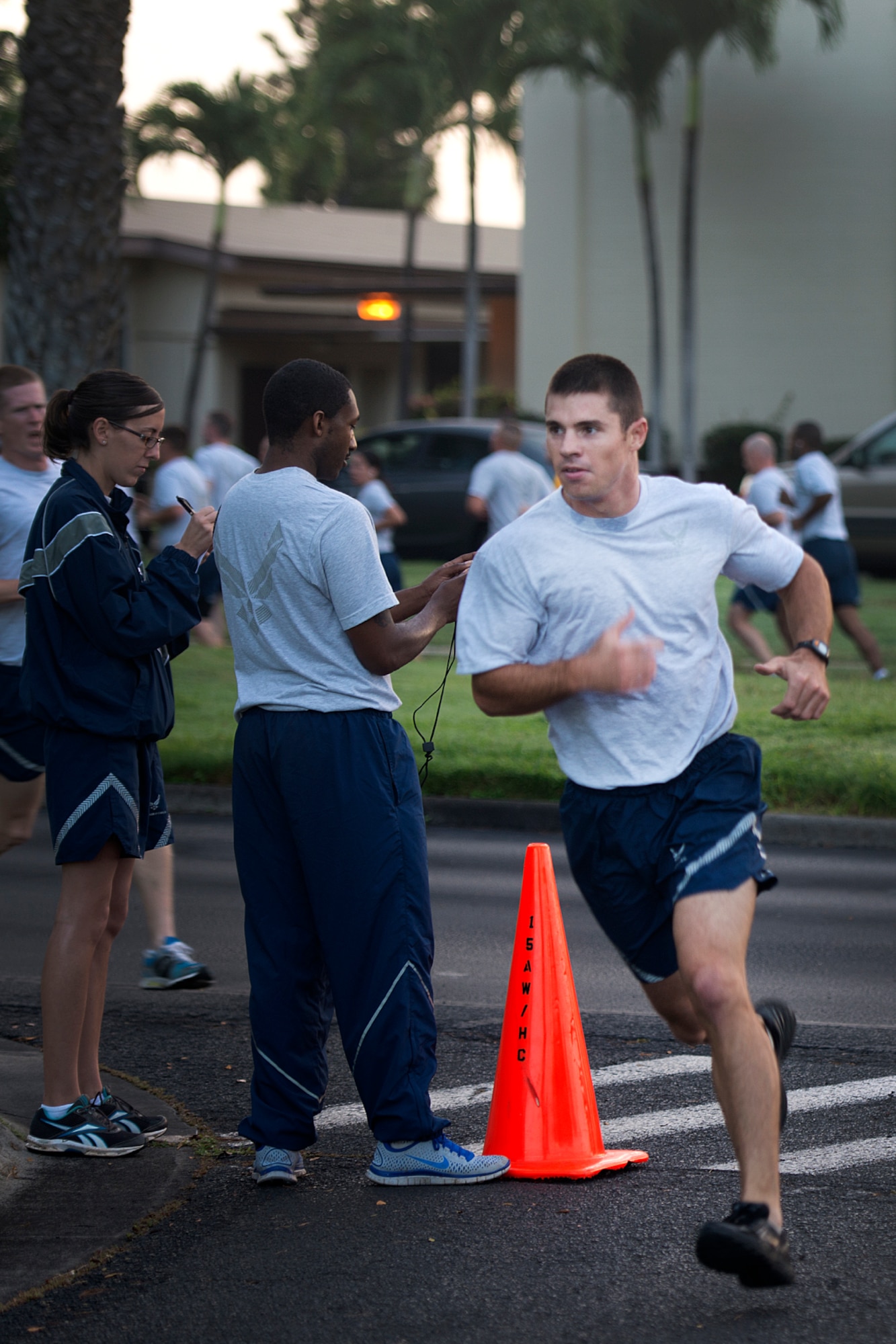 Capt. Jack Glojek, 647th Security Forces Squadron deputy commander, turns the corner to finish first with a 2.2-mile run time of 12:51 during the monthly fun run Dec. 6, 2012, on Hickam Field, Joint Base Pearl Harbor-Hickam, Hawaii. The joint service run is typically held the first Friday of each month, but was moved for Dec. 7 ceremonies. The run recently changed the format from a formation run. Tech. Sgt. Andrew Wickerham, 15th Maintenance Squadron and Airman 1st Class Cote Richard finished second and third respectively. The top three female finishers were Capt. Aspen Hager, 15th Medical Operations Squadron, Tech. Sgt. Elsie Garza, 647th Force Support Squadron, and Senior Airman Maricca Magdalera, 561st Network Operations Squadron, respectively. (U.S. Air Force Base photo/Staff Sgt. Mike Meares)
