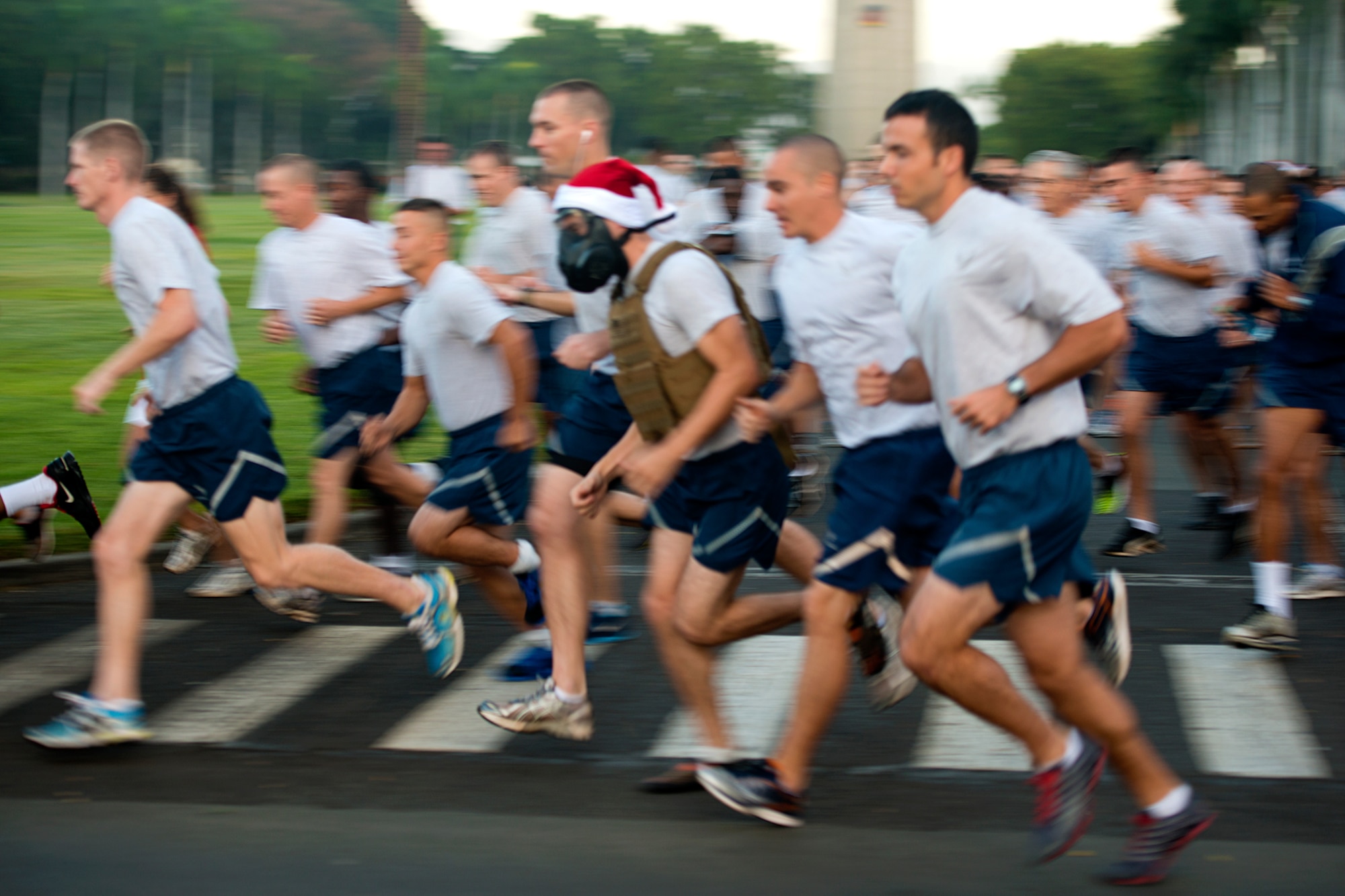 Airmen, Sailors and family members take off at the beginning of the monthly 2.2-mile fun run Dec. 6, 2012, at Joint Base Pearl Harbor-Hickam, Hawaii. The joint service run is typically held the first Friday of each month, but was moved for Dec. 7 ceremonies. (U.S. Air Force Base photo/Staff Sgt. Mike Meares)