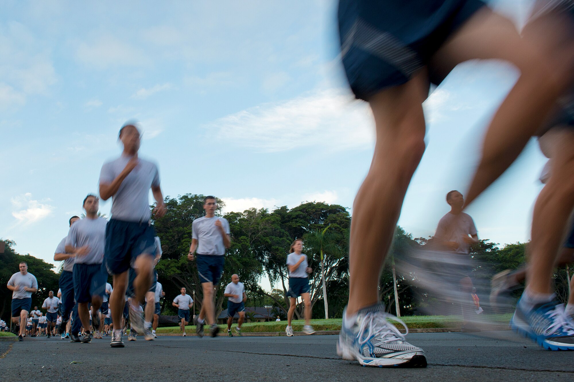 Airmen, Sailors and family members take off at the beginning of the monthly 2.2-mile fun run Dec. 6, 2012, at Joint Base Pearl Harbor-Hickam, Hawaii. The joint service run is typically held the first Friday of each month, but was moved for Dec. 7 ceremonies. (U.S. Air Force Base photo/Staff Sgt. Mike Meares)