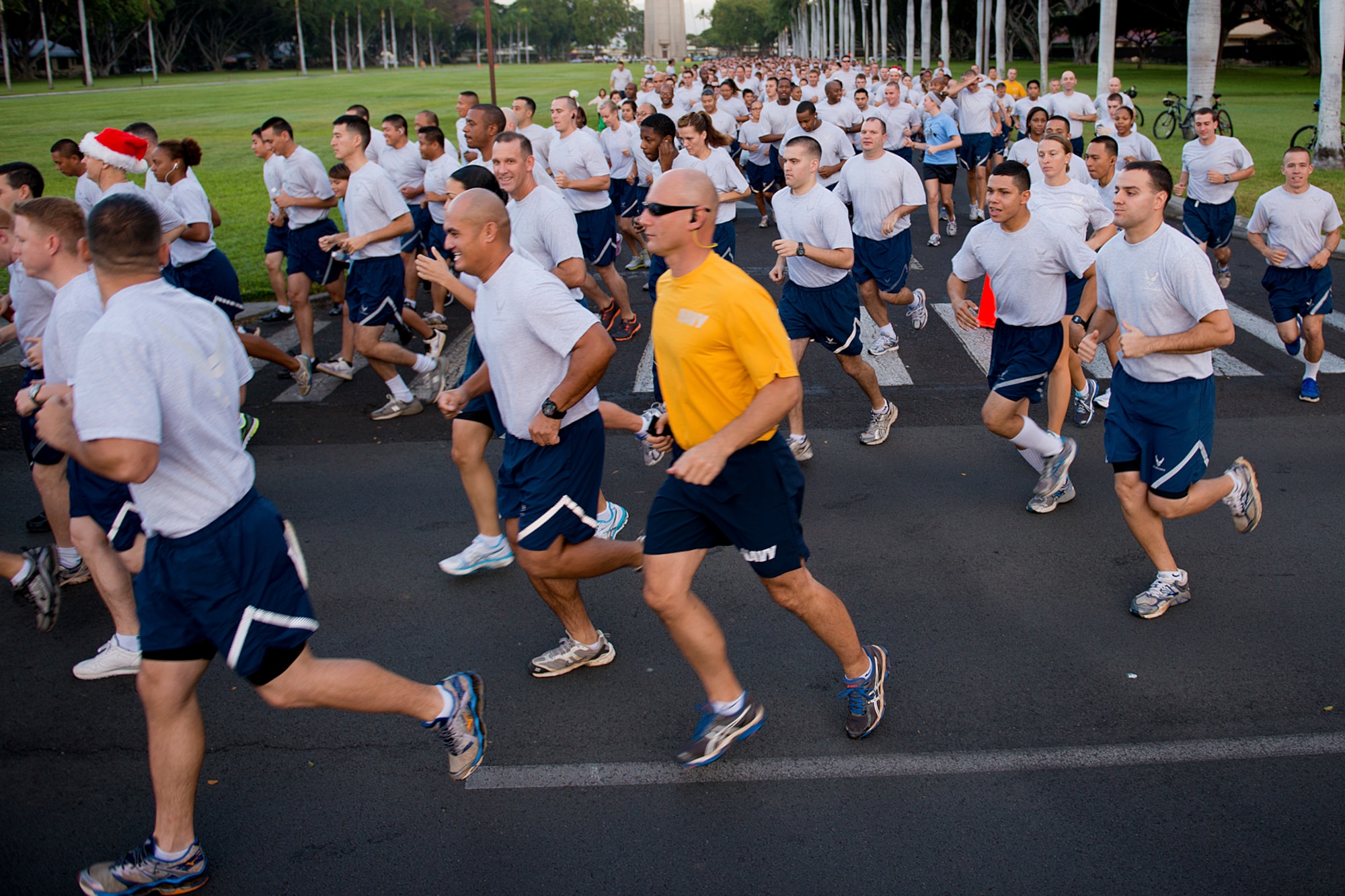 Airmen, Sailors and family members take off at the beginning of the monthly 2.2-mile fun run Dec. 6, 2012, at Joint Base Pearl Harbor-Hickam, Hawaii. The joint service run is typically held the first Friday of each month, but was moved for Dec. 7 ceremonies. (U.S. Air Force Base photo/Staff Sgt. Mike Meares)