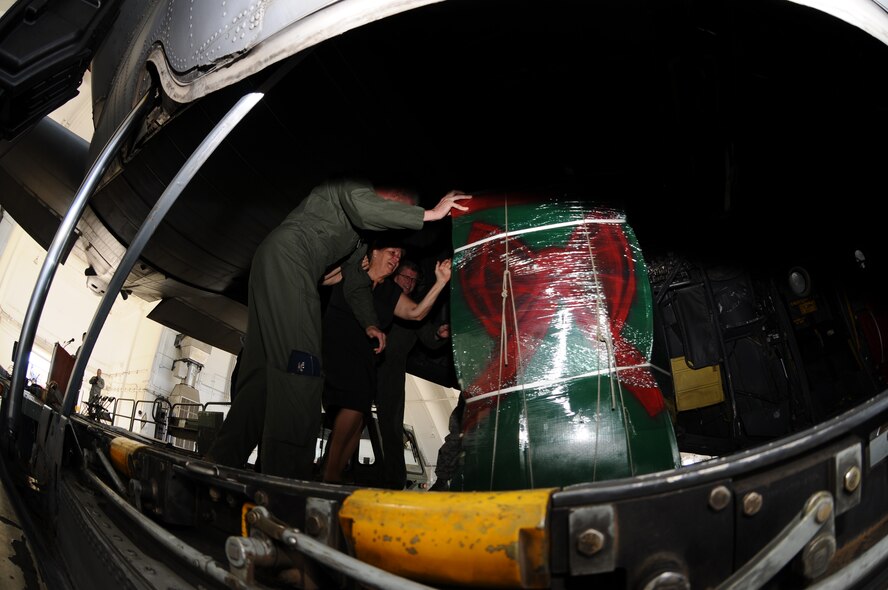 Members of Andersen, Yokota and the Guam local community push the first ceremonial box onto a waiting C-130 Hercules during the Operation Christmas Drop Push Ceremony at Andersen Air Force Base, Guam on Dec. 11, 2012. Operation Christmas Drop is a non-profit organization powered by volunteers from Andersen Air Force Base and the local Guam community. Each year OCD provides aid to more than 30,000 islanders in Chuuk, Palau, Yap, Marshall Islands and Commonwealth of the Northern Mariana Islands. This year is the 61st anniversary of OCD, making it the longest running humanitarian mission in the world. The day of the push ceremony was the first of eight planned days of air drops with 16 total airdrops to 54 islands planned during OCD. The day of the OCD push ceremony was the first of eight planned days of air drops with 16 total airdrops to 54 islands planned.  (U.S. Air Force photo by Senior Carlin Leslie/Released)