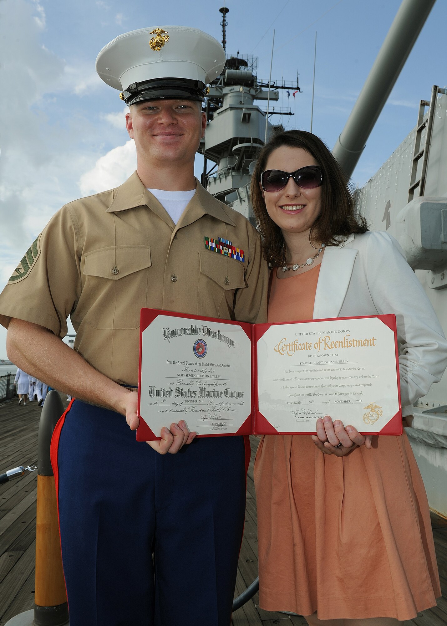 U.S. Marine Corps Staff Sgt. Jordan E. Tilley, 3rd Battalion, signal intelligence radioman, and his spouse, Mrs. Ashley Tilley, pose with his certificate of re-enlistment aboard the USS Missouri Memorial, Pearl Harbor, Hawaii, Dec. 7, 2012. Tilley was one of 54 service members who participated in a special re-enlistment ceremony on the 71st Anniversary of the Pearl Harbor attacks. (U.S. Air Force photo/Jerome S. Tayborn)