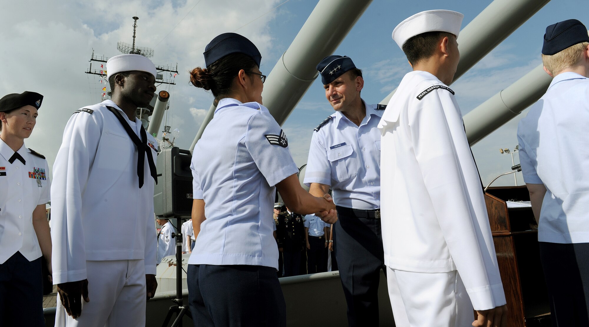Lt. Gen. Ted Kresge, Pacific Air Forces vice commander, congratulates Senior Airman Skyla L. Spotkaeff, a bioenvironmental engineering technician with the 15th Aerospace Medicine Squadron, shortly after presiding over a mass joint service re-enlistment ceremony aboard the USS Missouri Memorial, Pearl Harbor, Hawaii, Dec. 7, 2012. Spotkaeff was one of 54 service members who participated in this special ceremony that also honored the heroic actions of those who defended Pearl Harbor during the tragic attacks on Dec. 7, 1941. (U.S. Air Force photo/Tech. Sgt. Jerome S. Tayborn)