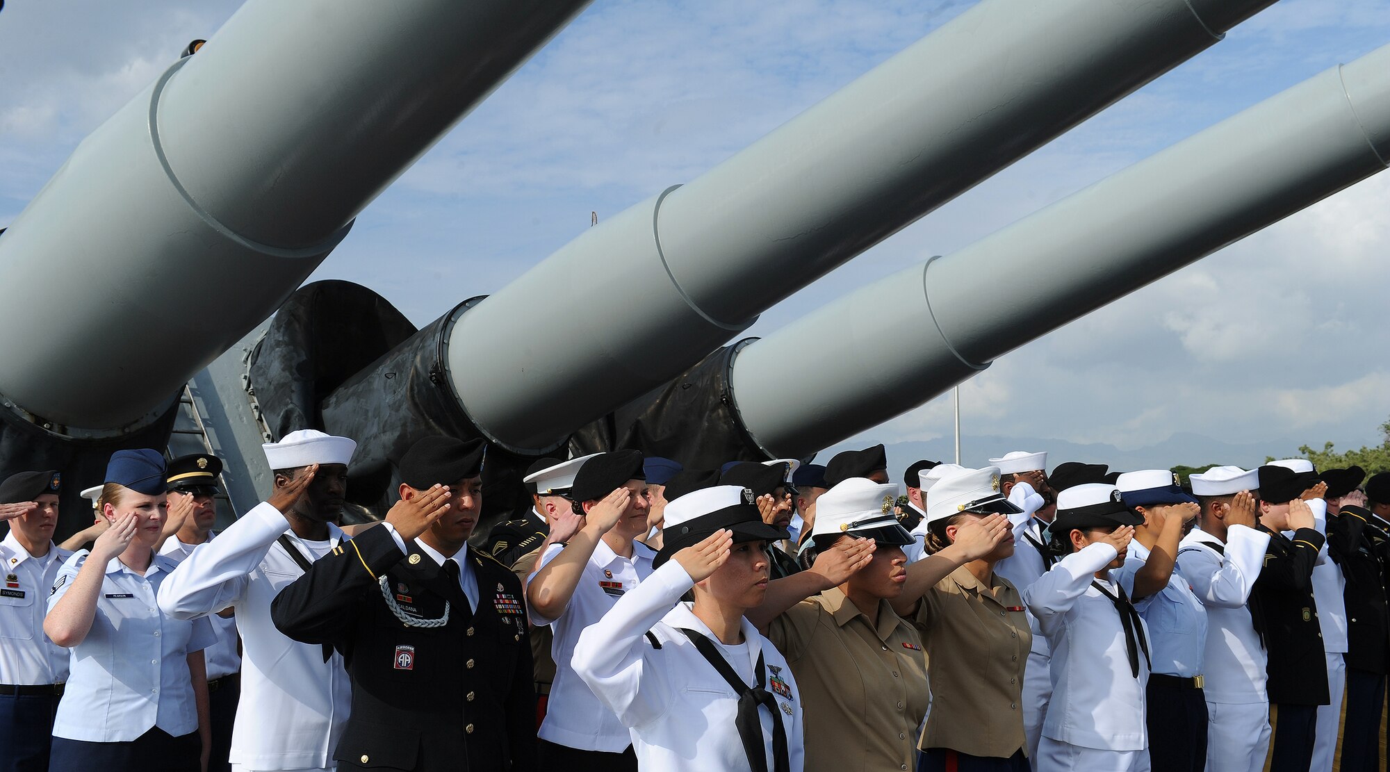 A formation of re-enlistees render salutes during the playing of the nation anthem aboard the USS Missouri Memorial, Pearl Harbor, Hawaii, Dec. 7, 2012.  The enlistees, representing all services, participated in a special reenlistment ceremony on the 71st anniversary of the Pearl Harbor attacks. (U.S. Air Force photo/Tech. Sgt. Jerome S. Tayborn)