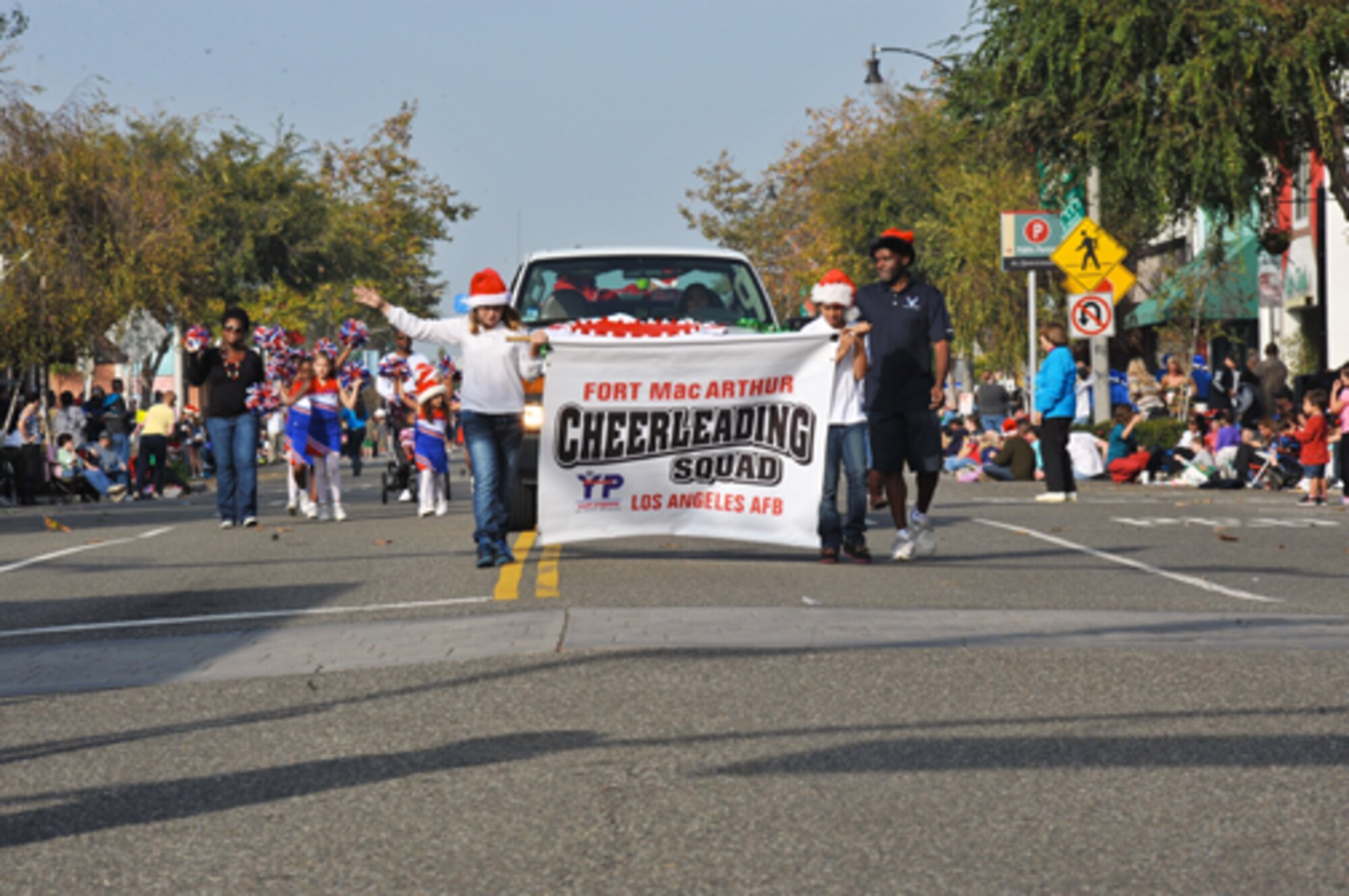 The Fort MacArthur Cheerleading Squad marches in the El Segundo Holiday Parade, Dec. 9.  (Photo by Sarah Corrice)