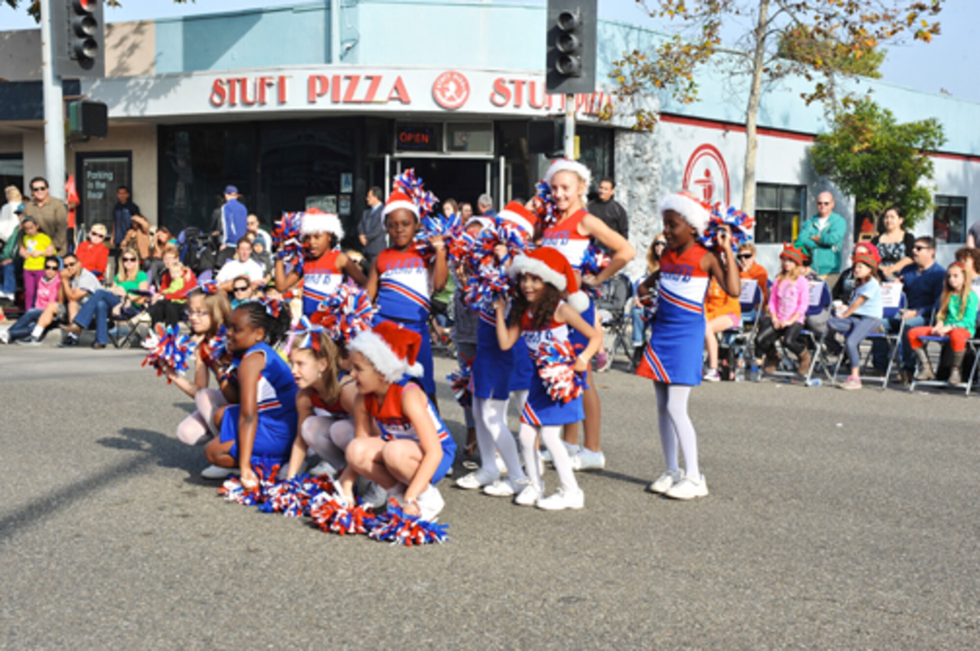The Fort MacArthur Cheerleading Squad performs a cheer during the El Segundo Holiday Parade, Dec. 9.  (Photo by Sarah Corrice)