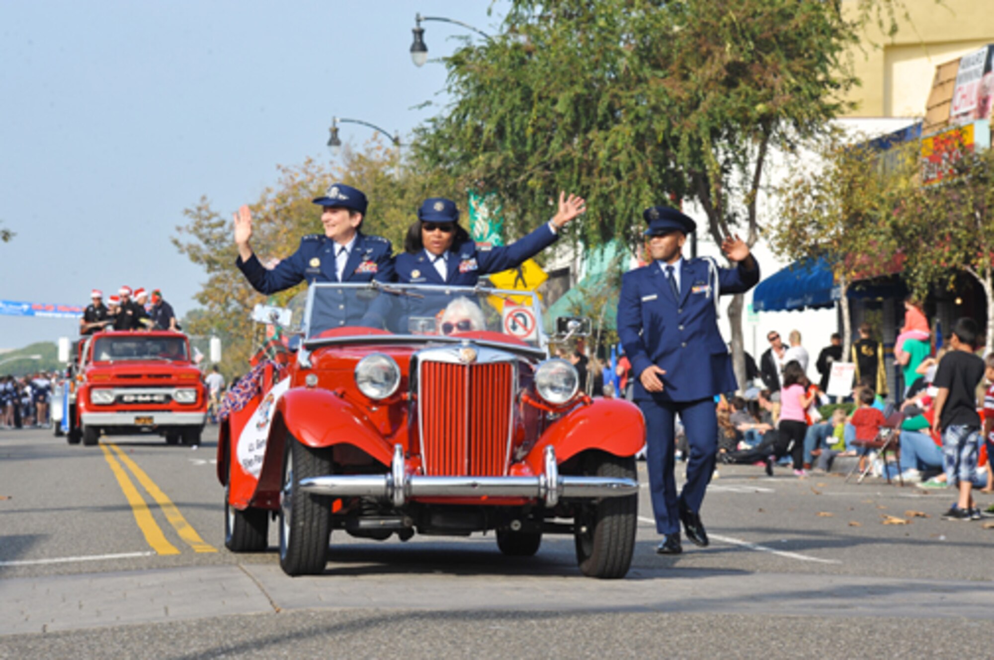Lieutenant General Ellen Pawlikowski, SMC commander, and Command Chief Master Sgt. Carol Dockery wave to the crowds during the El Segundo Holiday Parade, Dec. 9.  (Photo by Sarah Corrice)