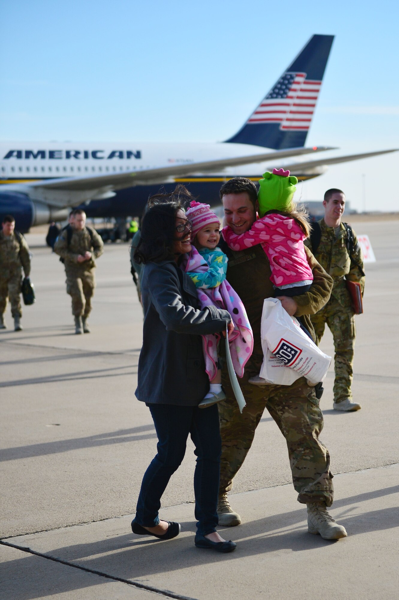 U.S. Staff Sgt. Adam Fineberg, 27 Special Operations Maintenance Operations Squadron quality assurance inspector, is greeted by his family during Operation Homecoming at Cannon Air Force Base, N.M., Dec. 9, 2012. Operation Homecoming is a monthly event held to welcome Air Commandos back from worldwide deployments and reunite them with their loved ones. (U.S. Air Force photo/Airman 1st Class Eboni Reece)