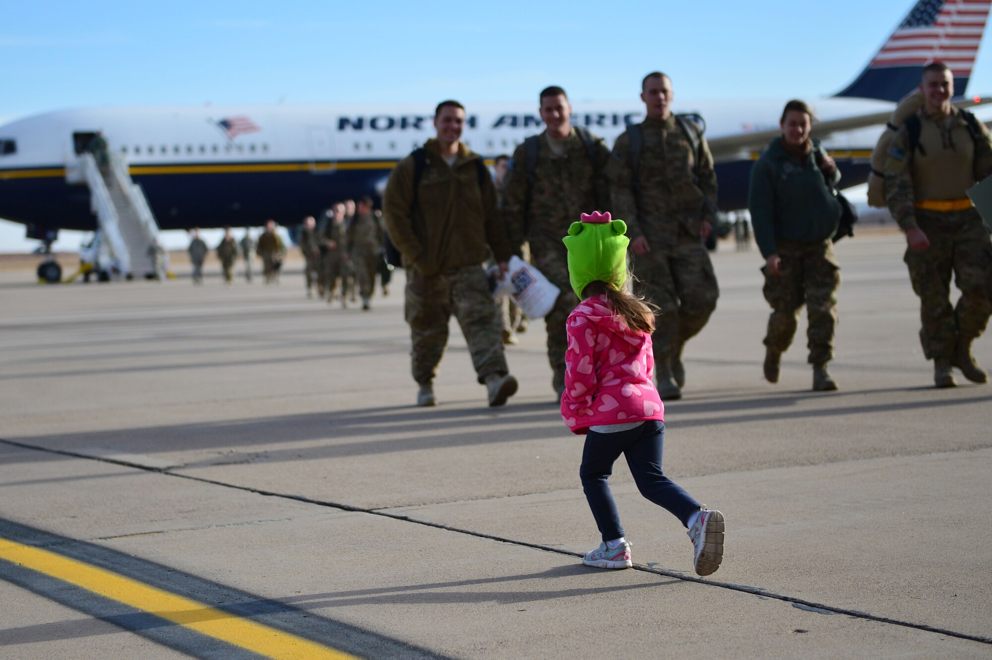 Daughter of U.S. Staff Sgt. Adam Fineberg, 27 Special Operations Maintenance Operations Squadron quality assurance inspector, runs toward her father during Operation Homecoming at Cannon Air Force Base, N.M., Dec. 9, 2012. Operation Homecoming is a monthly event held to welcome Air Commandos back from worldwide deployments and reunite them with their loved ones. (U.S. Air Force photo/Airman 1st Class Eboni Reece)